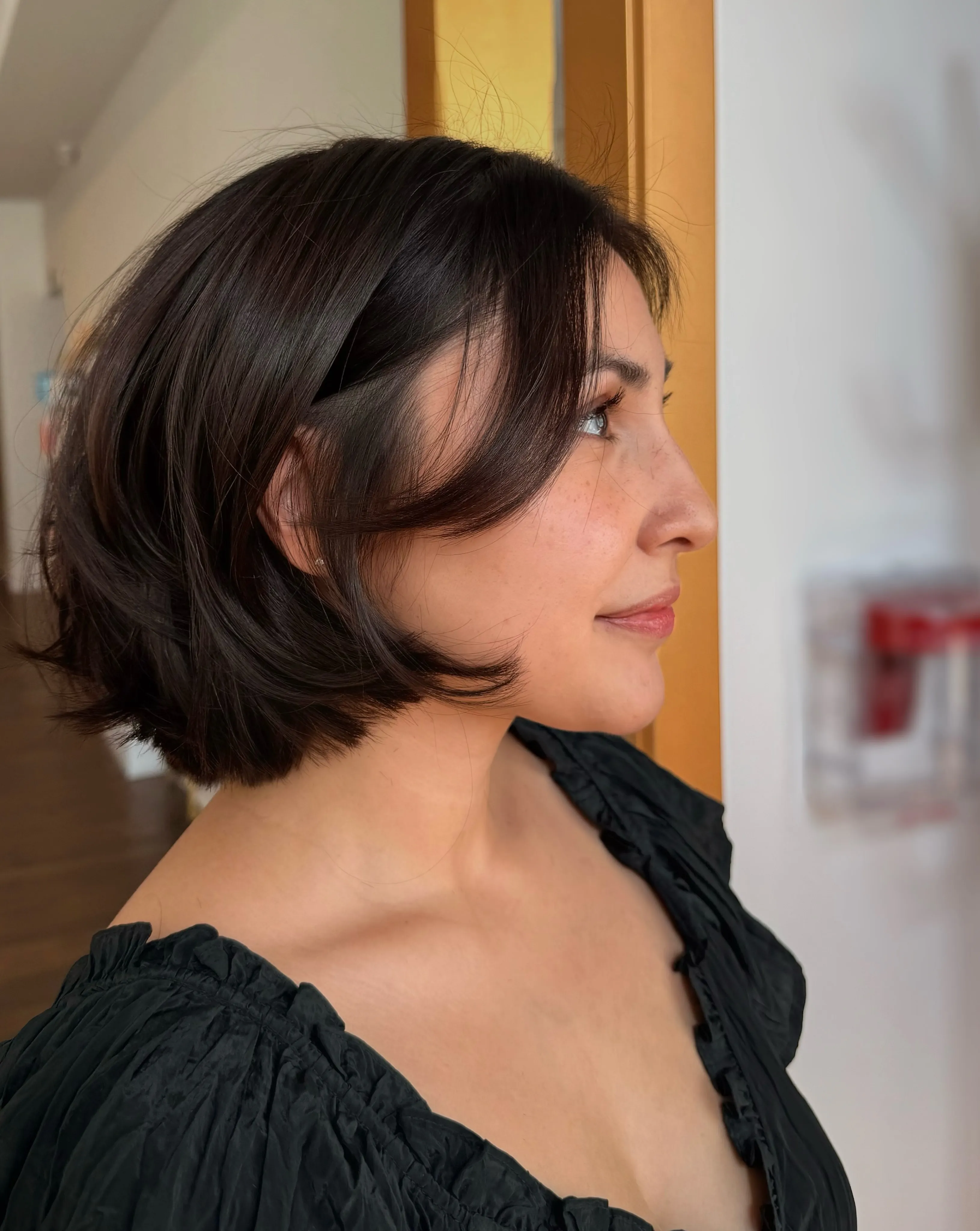 Sleek short layered bob with long side fringe