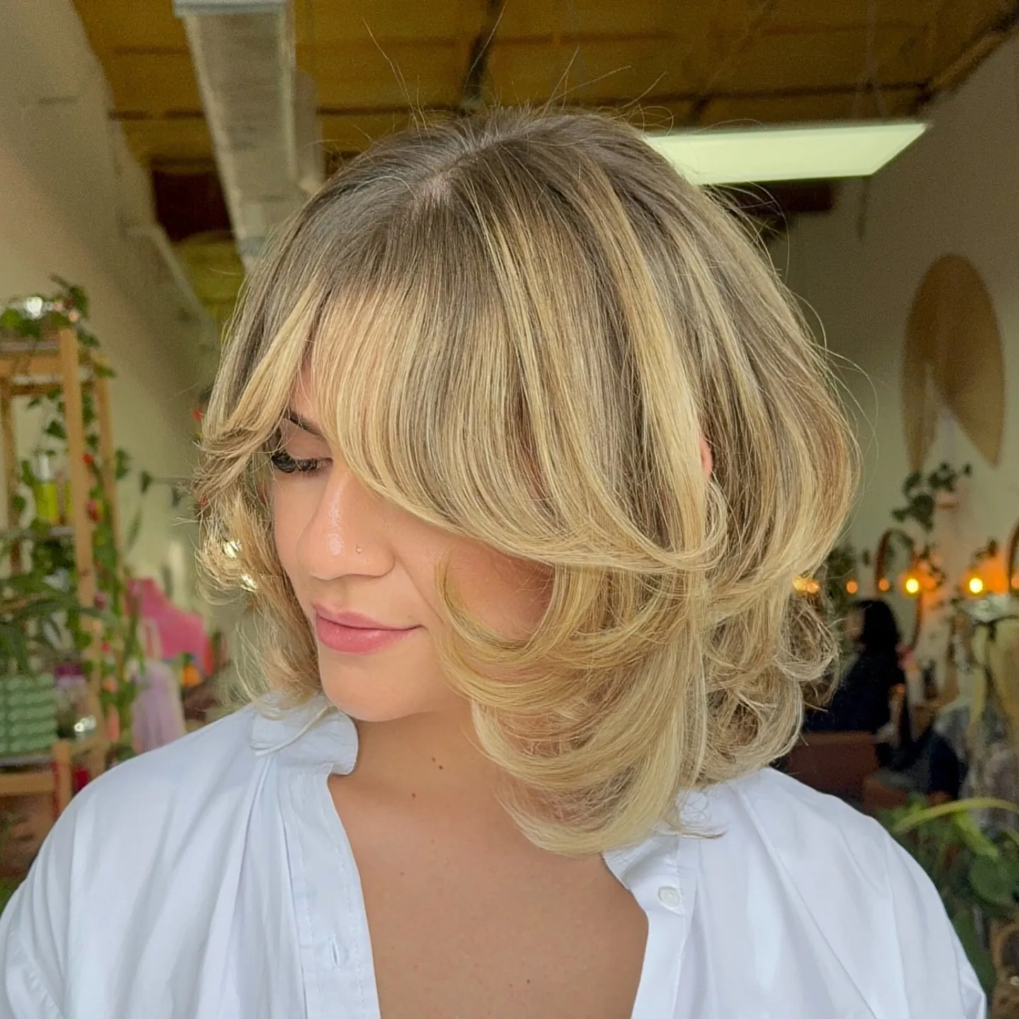 Feathered blonde layered bob with long curtain fringe