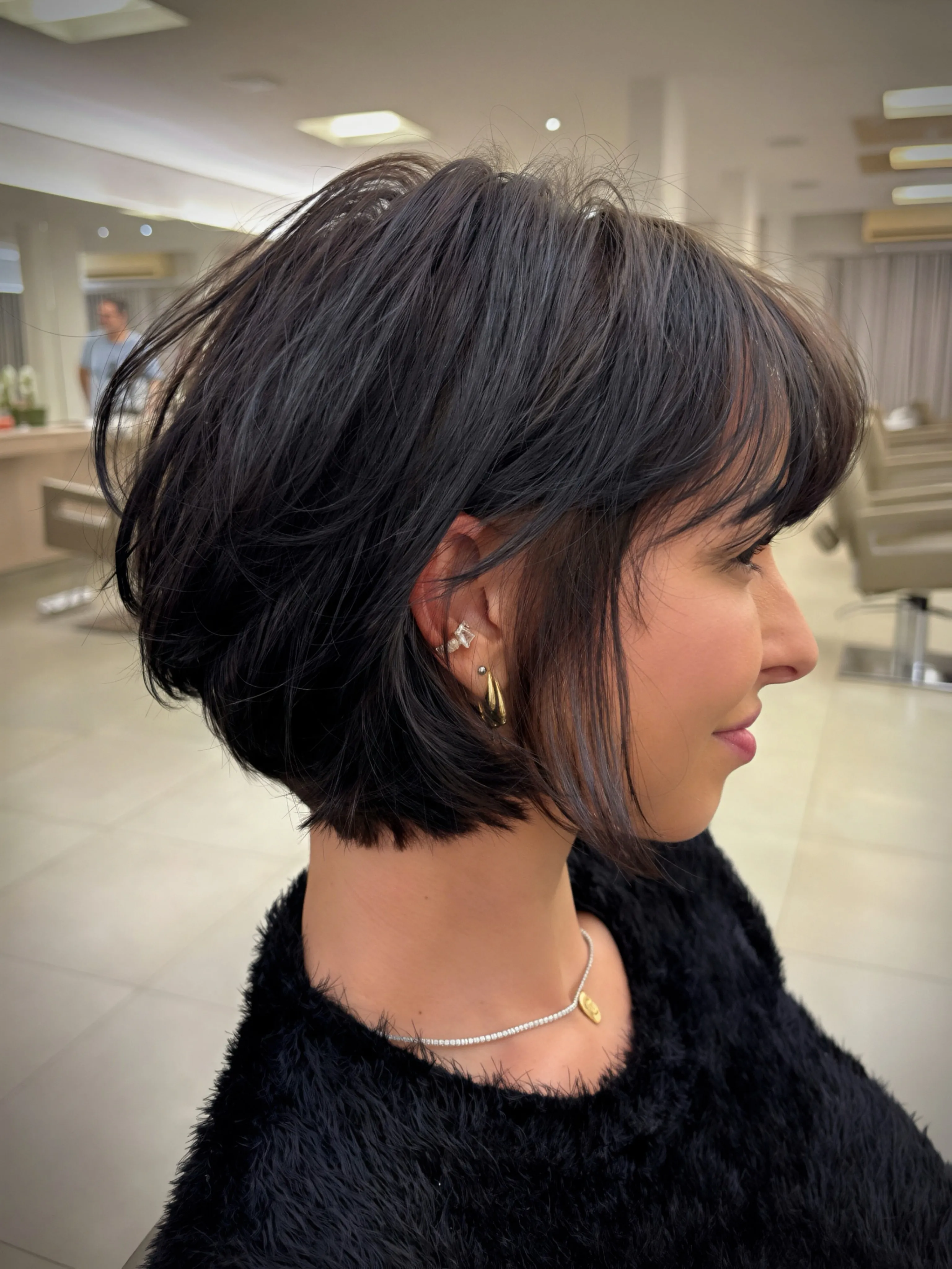 Short stacked layered bob with compact nape and crown volume