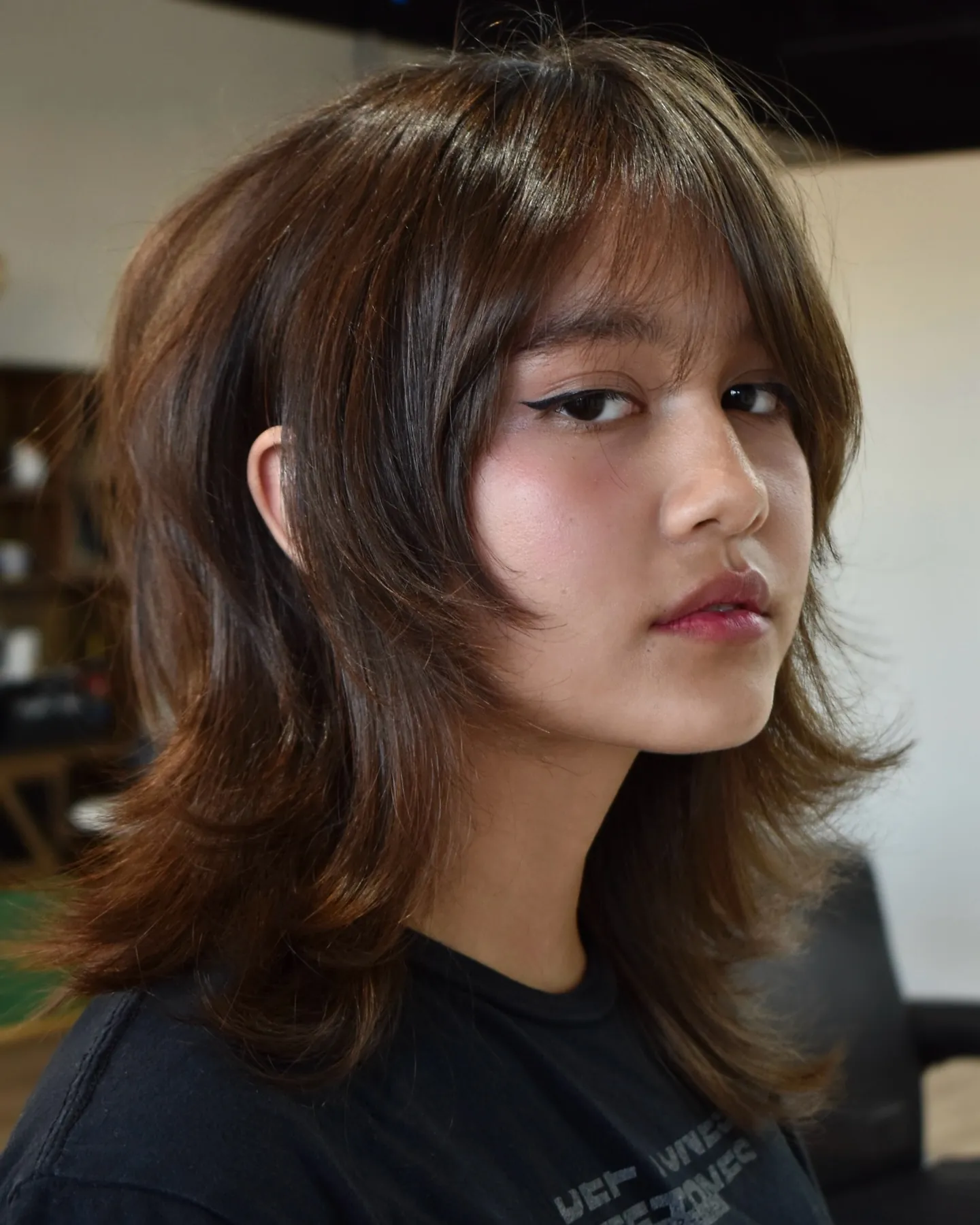 Shoulder-length shaggy layers with full bangs