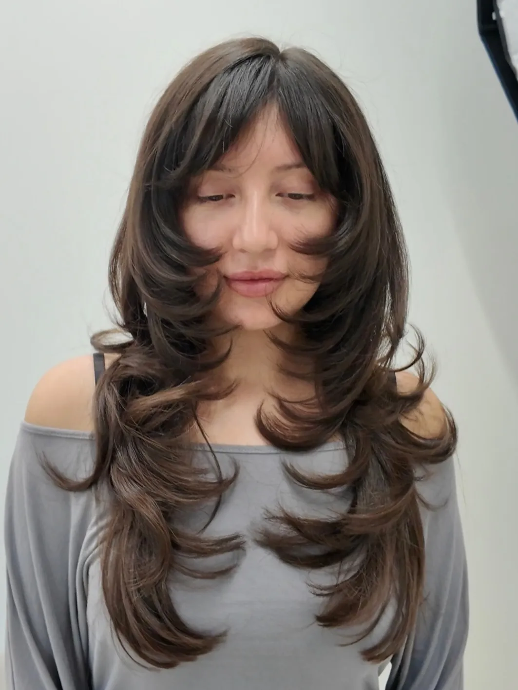 Long butterfly layers with curtain bangs