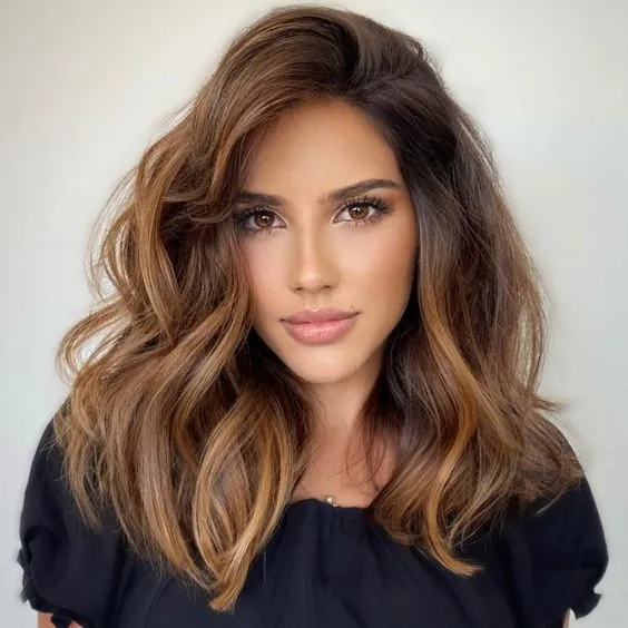 Wavy shoulder-length layers with side-swept volume