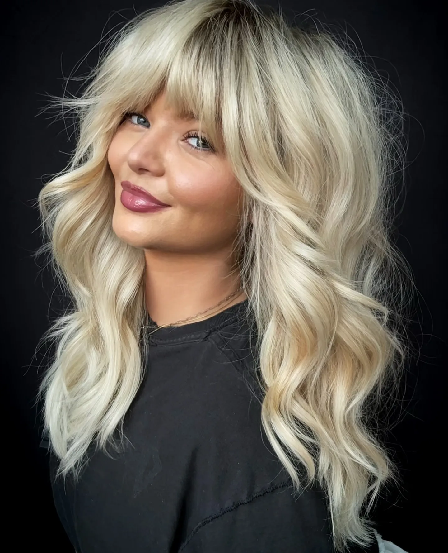 Wavy light blonde hair with full fringe
