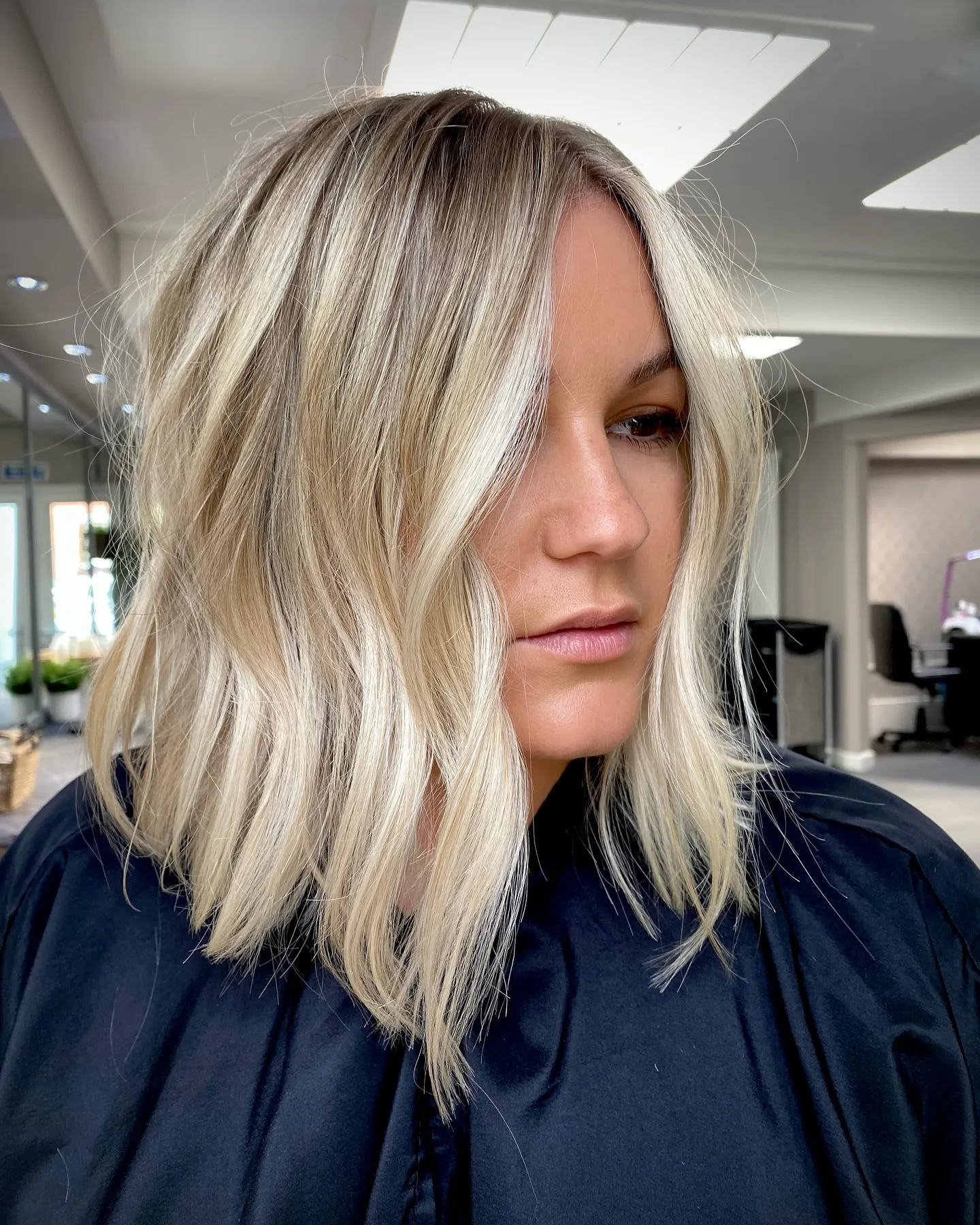 Textured light blonde lob with root depth