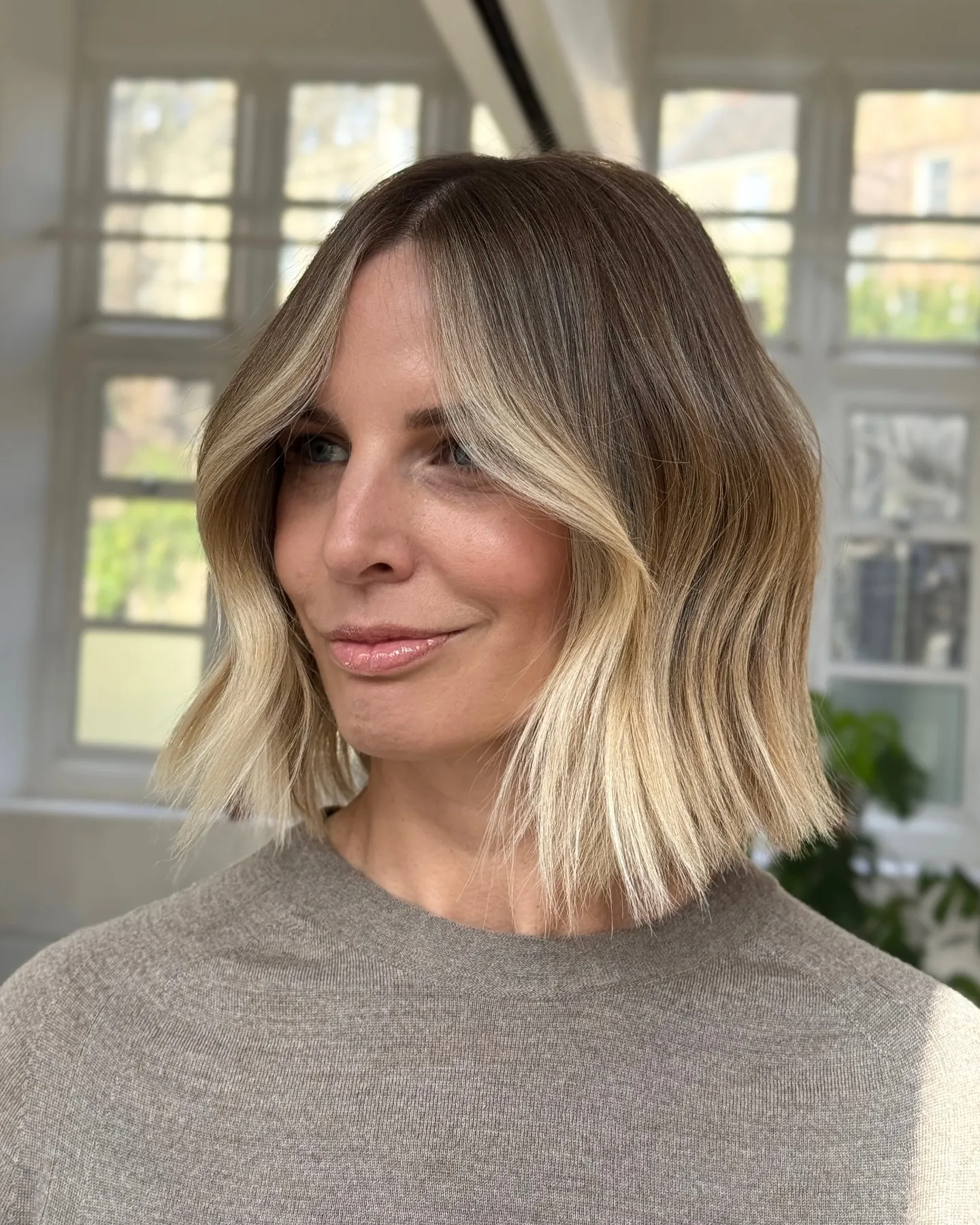 Blunt light blonde bob with darker roots