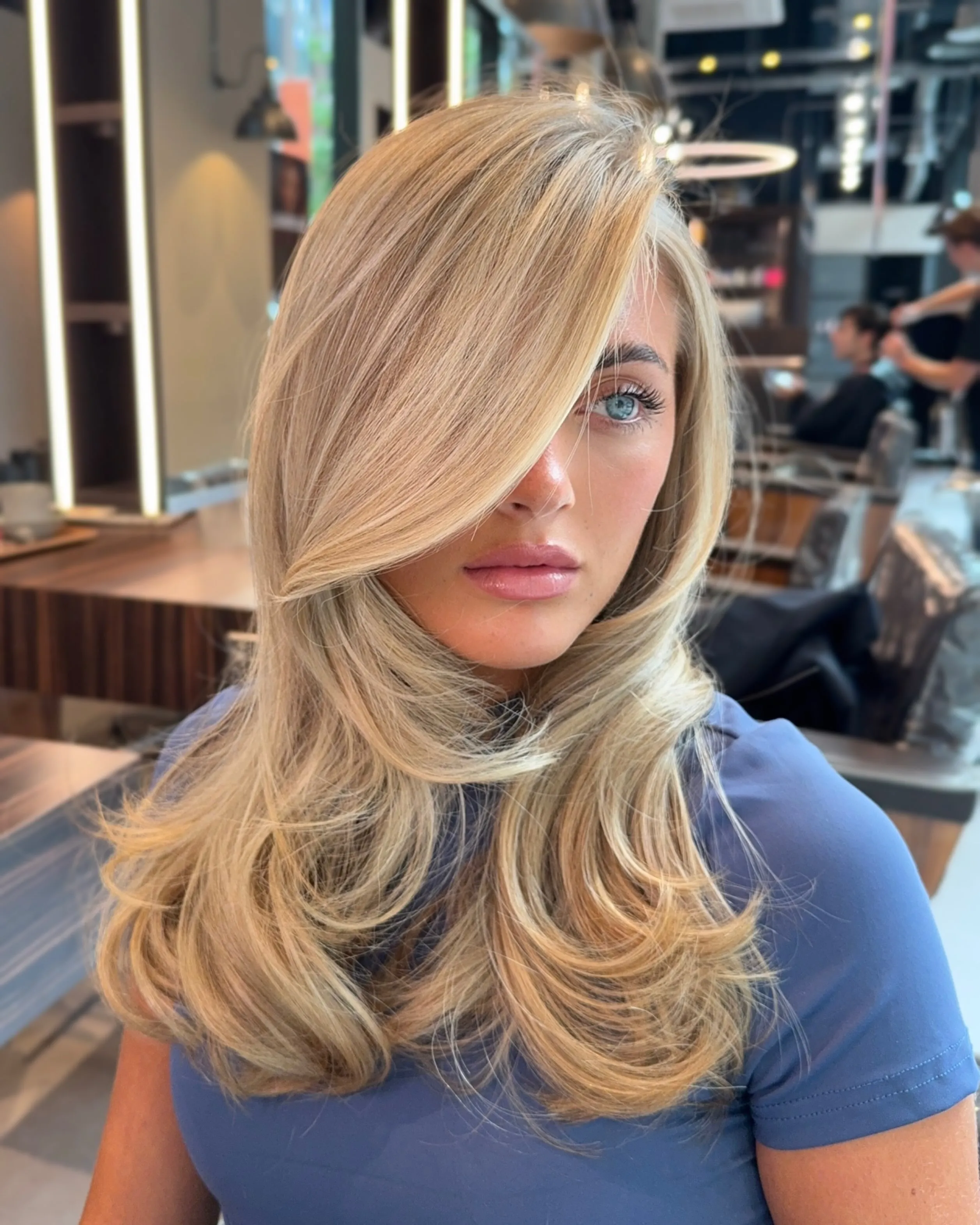 Feathered light blonde hair with side fringe