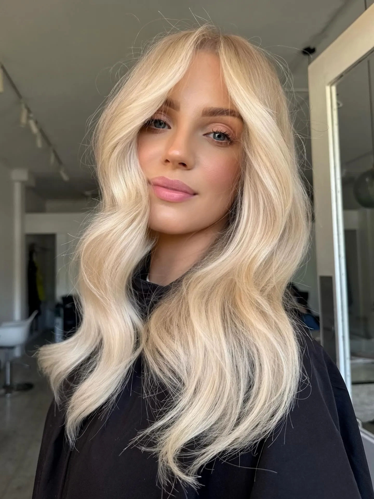 Long light blonde waves with centre part