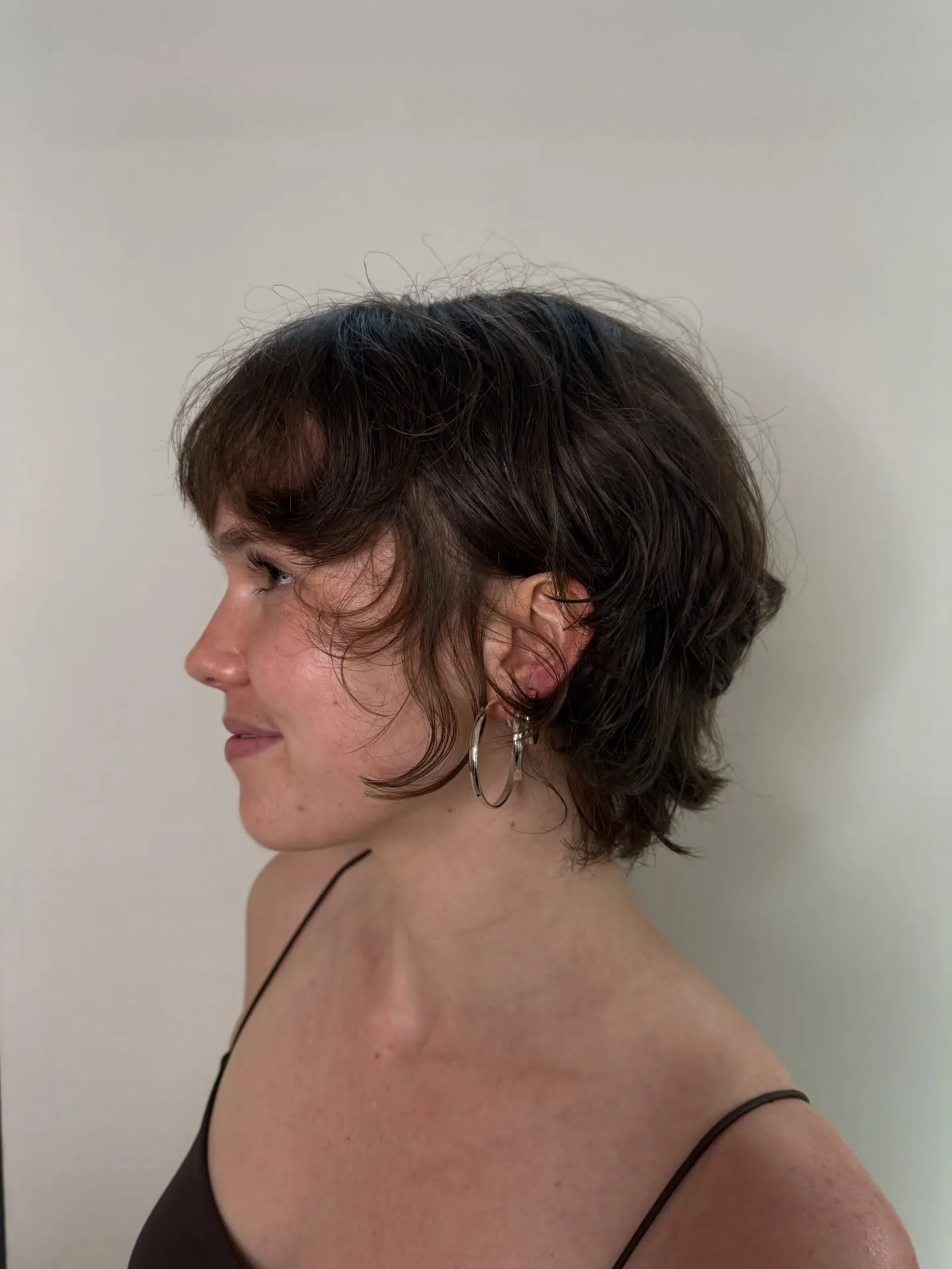 Rounded brunette bixie with soft fringe and tapered nape