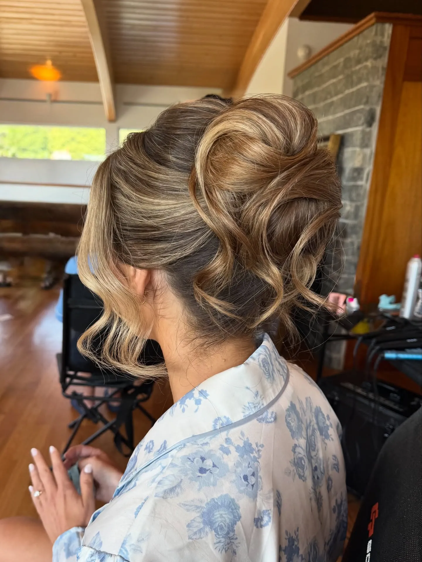 Sculpted curled wedding updo with large loops, swept front sections and loose tendrils