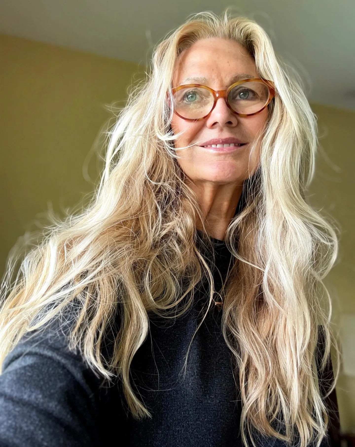 Tousled long blonde layers with a soft center part