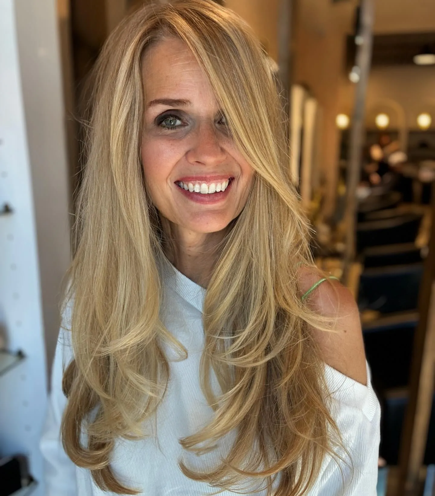 Face-framing long blonde layers with curled ends