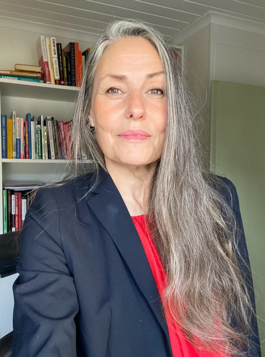 Very long straight silver hair with a side part