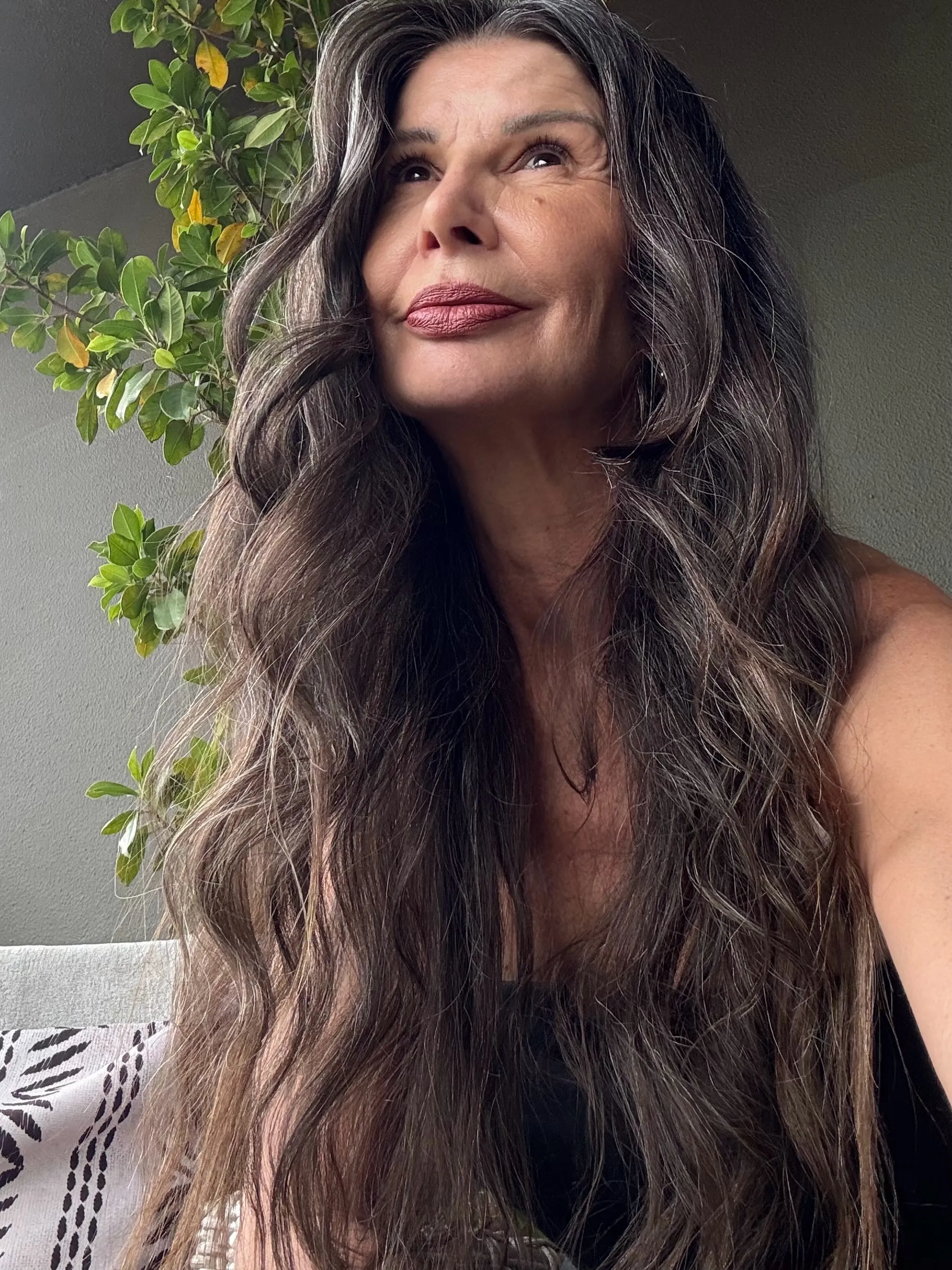 Long brunette waves with a soft side part