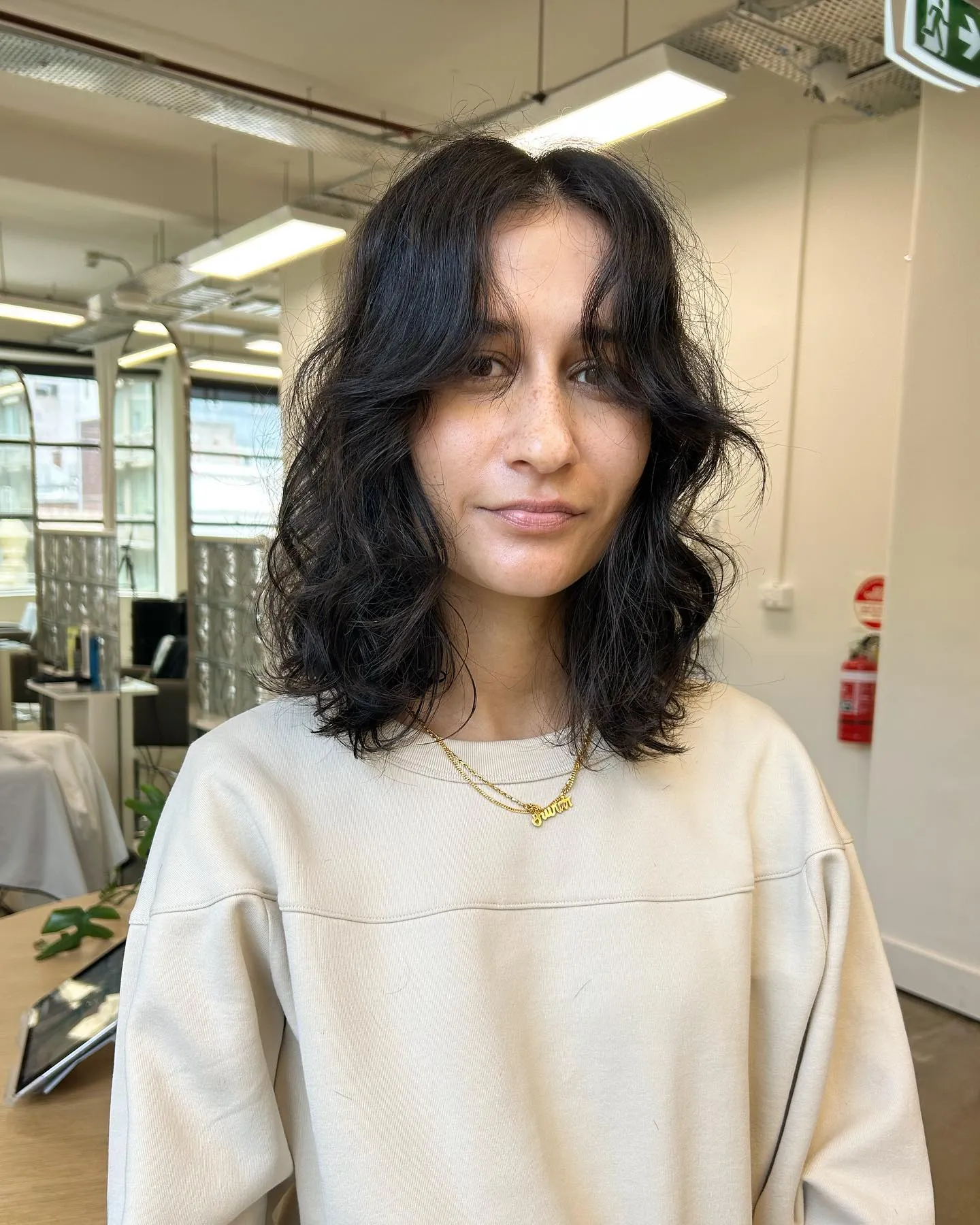 Centre-parted curly lob with natural volume