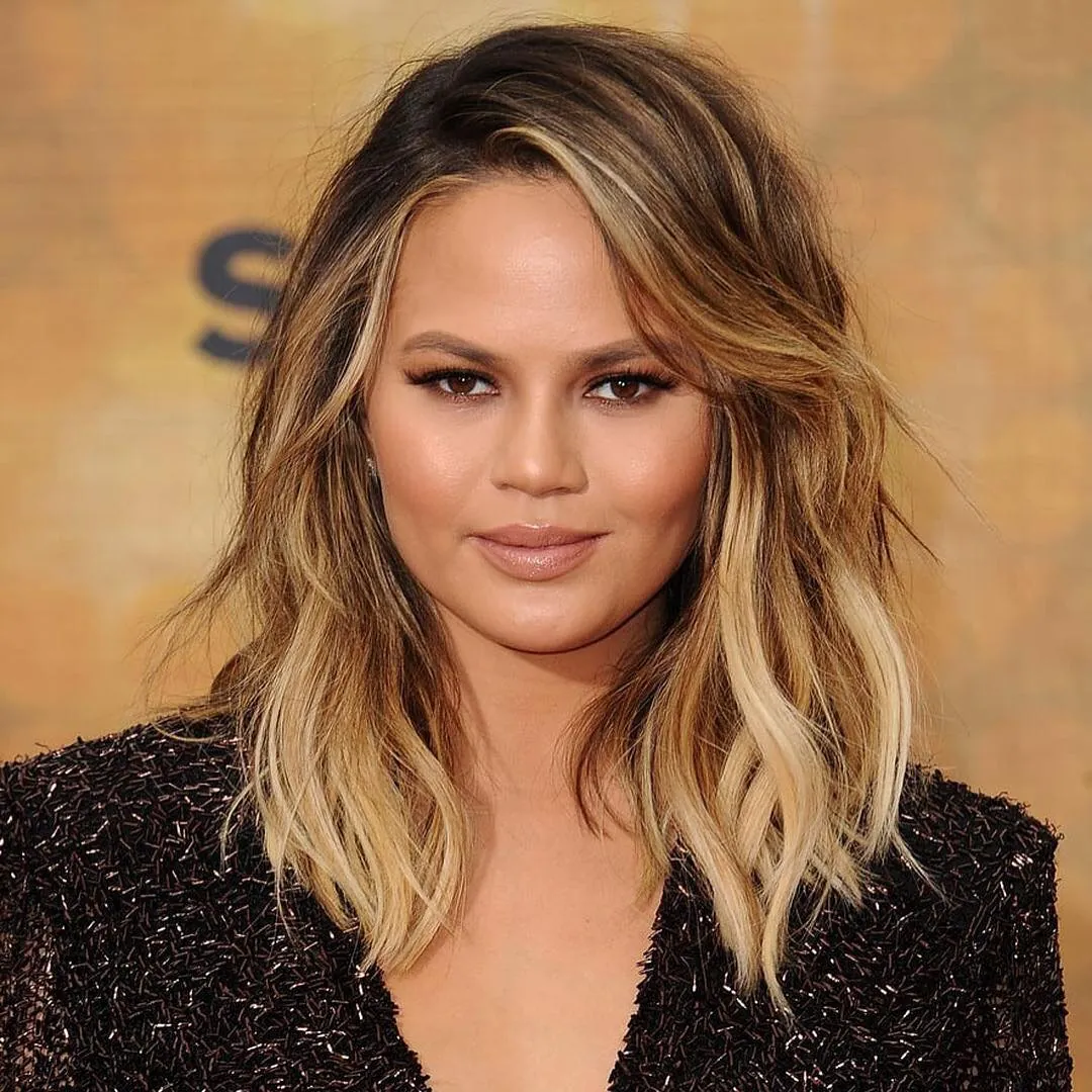 Side-parted blonde wavy lob with textured ends