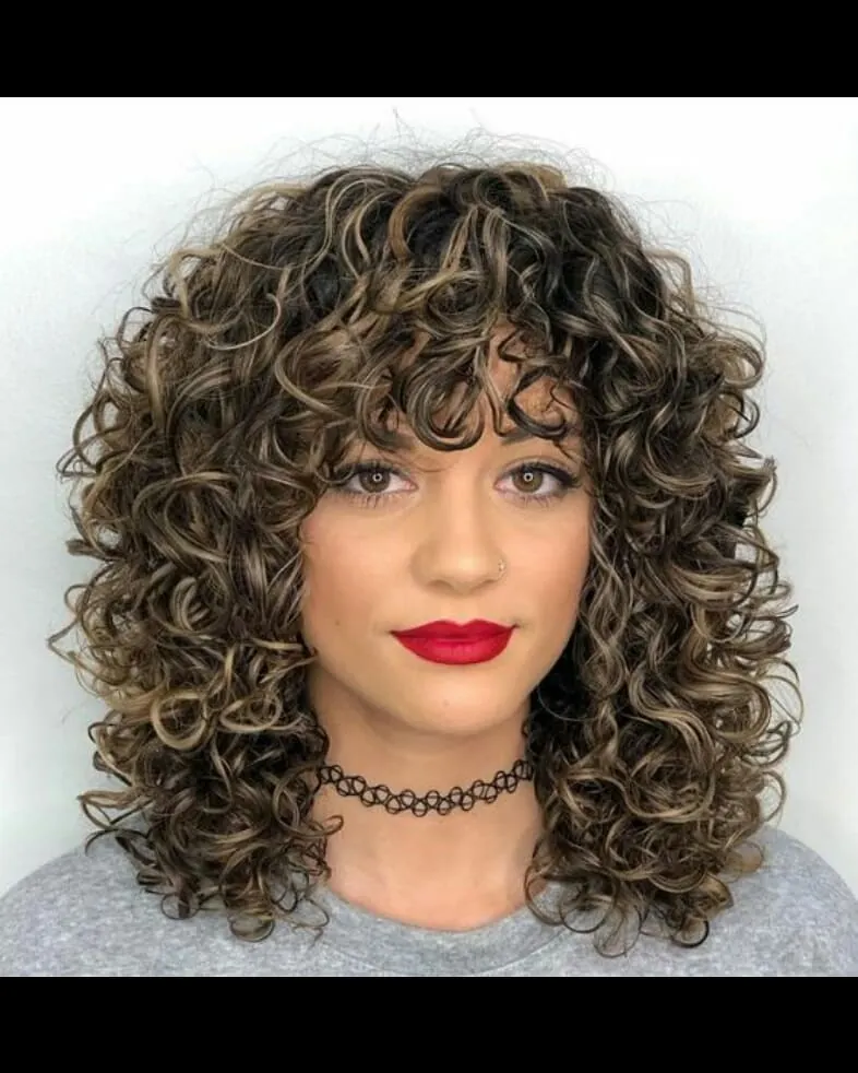 Shoulder-length curly cut with a curly fringe