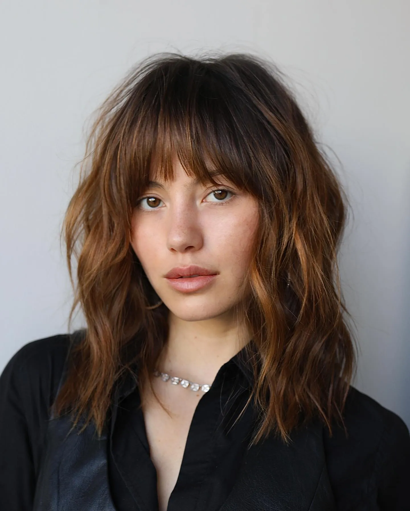 Wavy brunette shag with full bangs