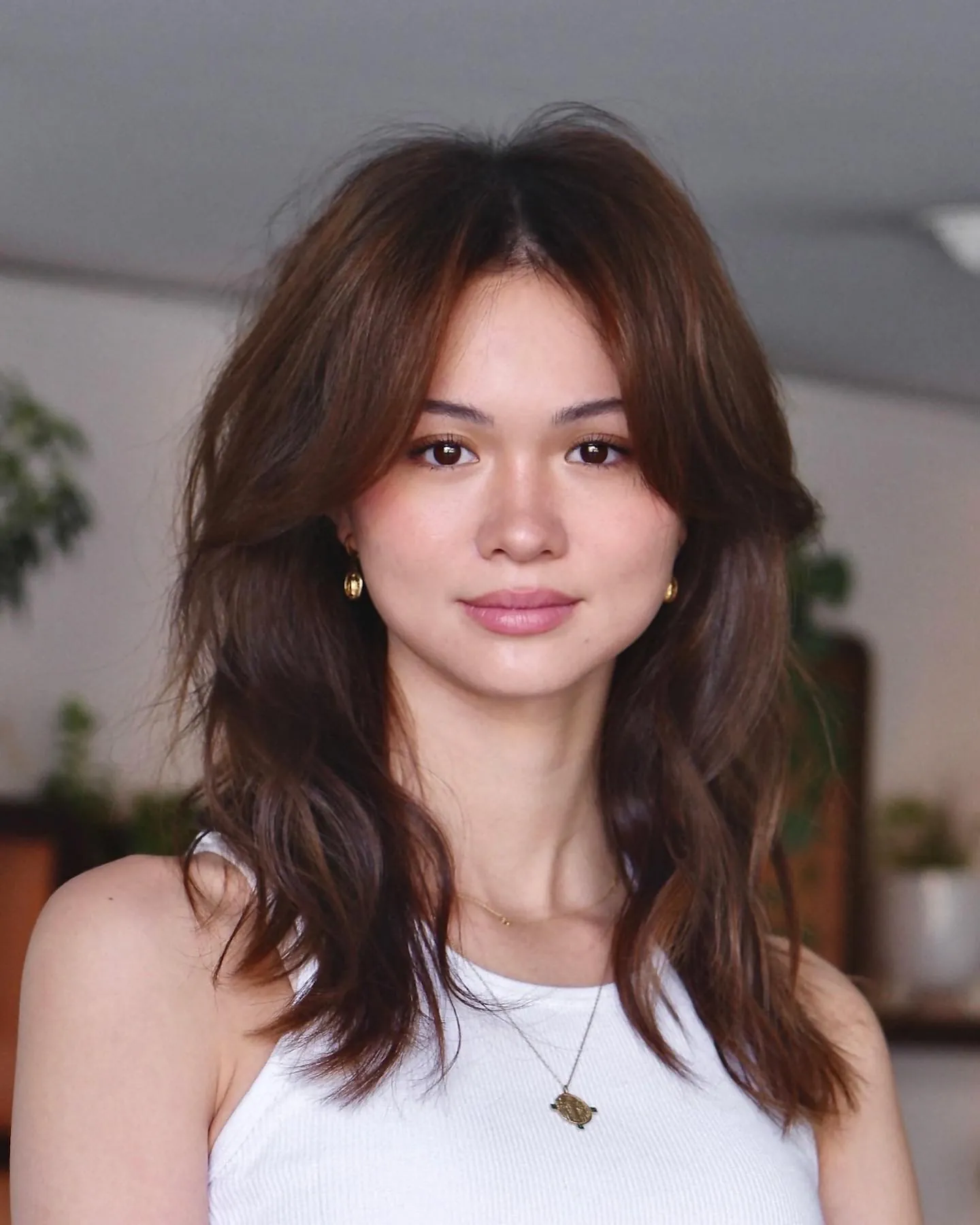 Center-parted layered brunette hair with soft waves