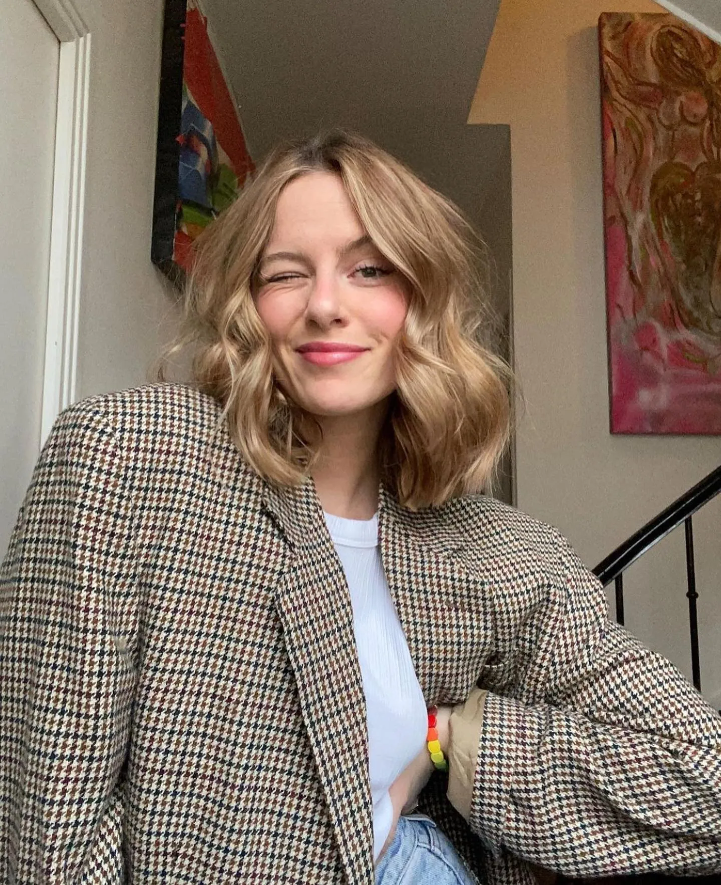 Center-parted shoulder-length blonde hair with loose waves