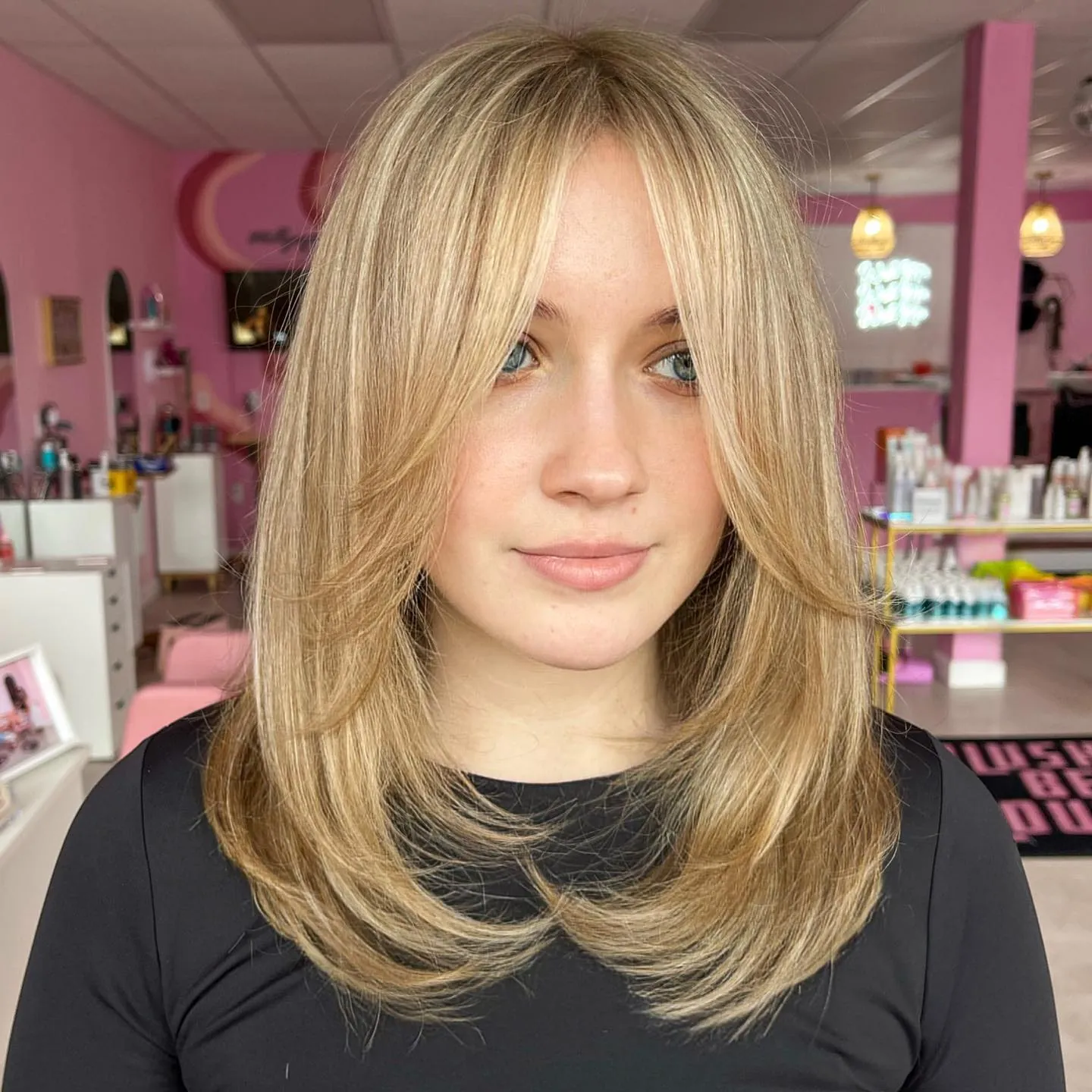 Blonde face-framing layers with a center part