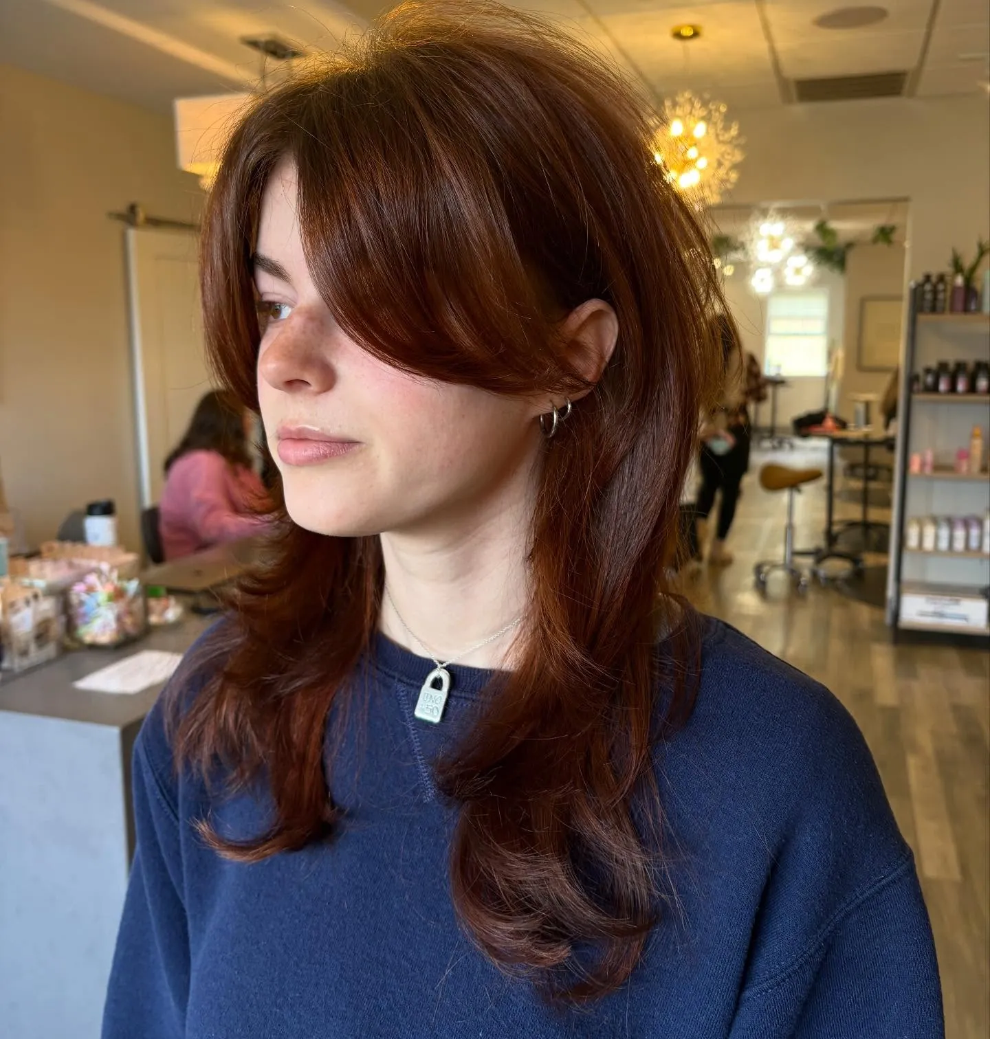 Copper shoulder-length layers with long curtain fringe