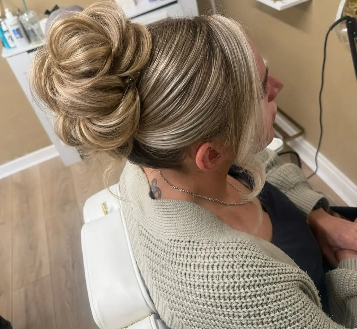 Full high blonde bun with smooth sides and rounded loops