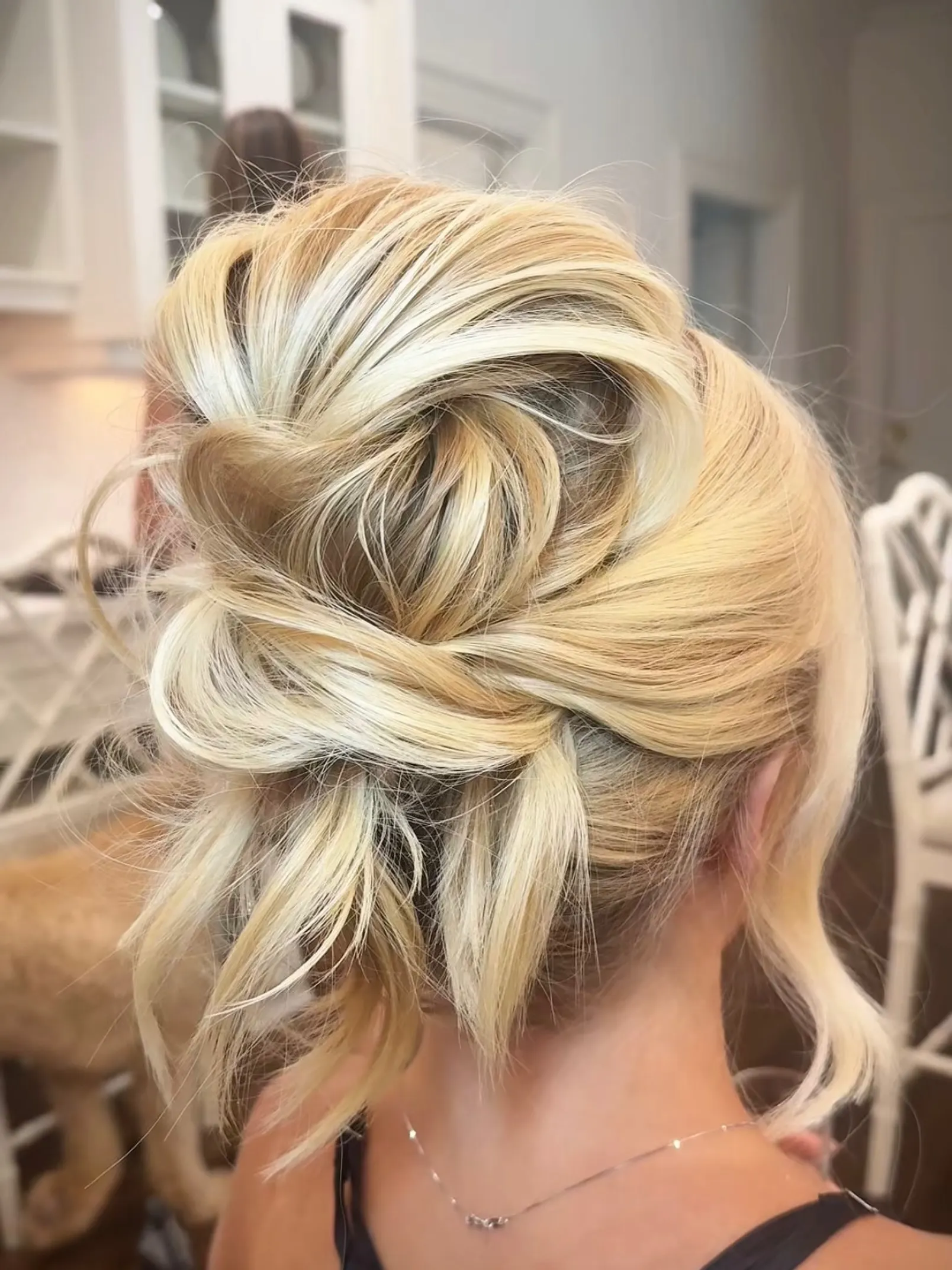 Airy high blonde bun made from loose overlapping loops