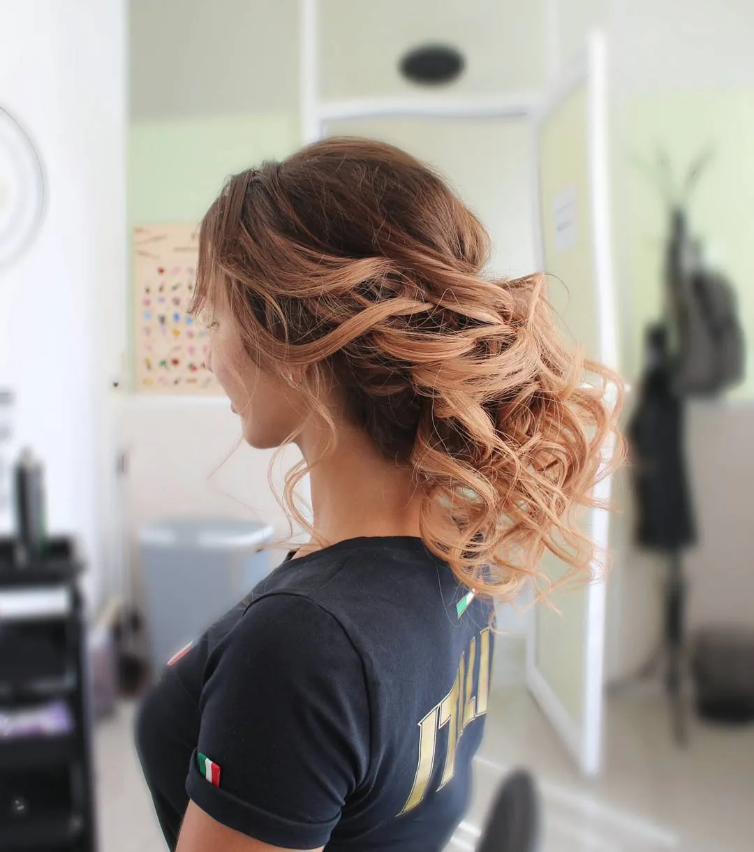 Loose cascading curled wedding bun on highlighted brown hair