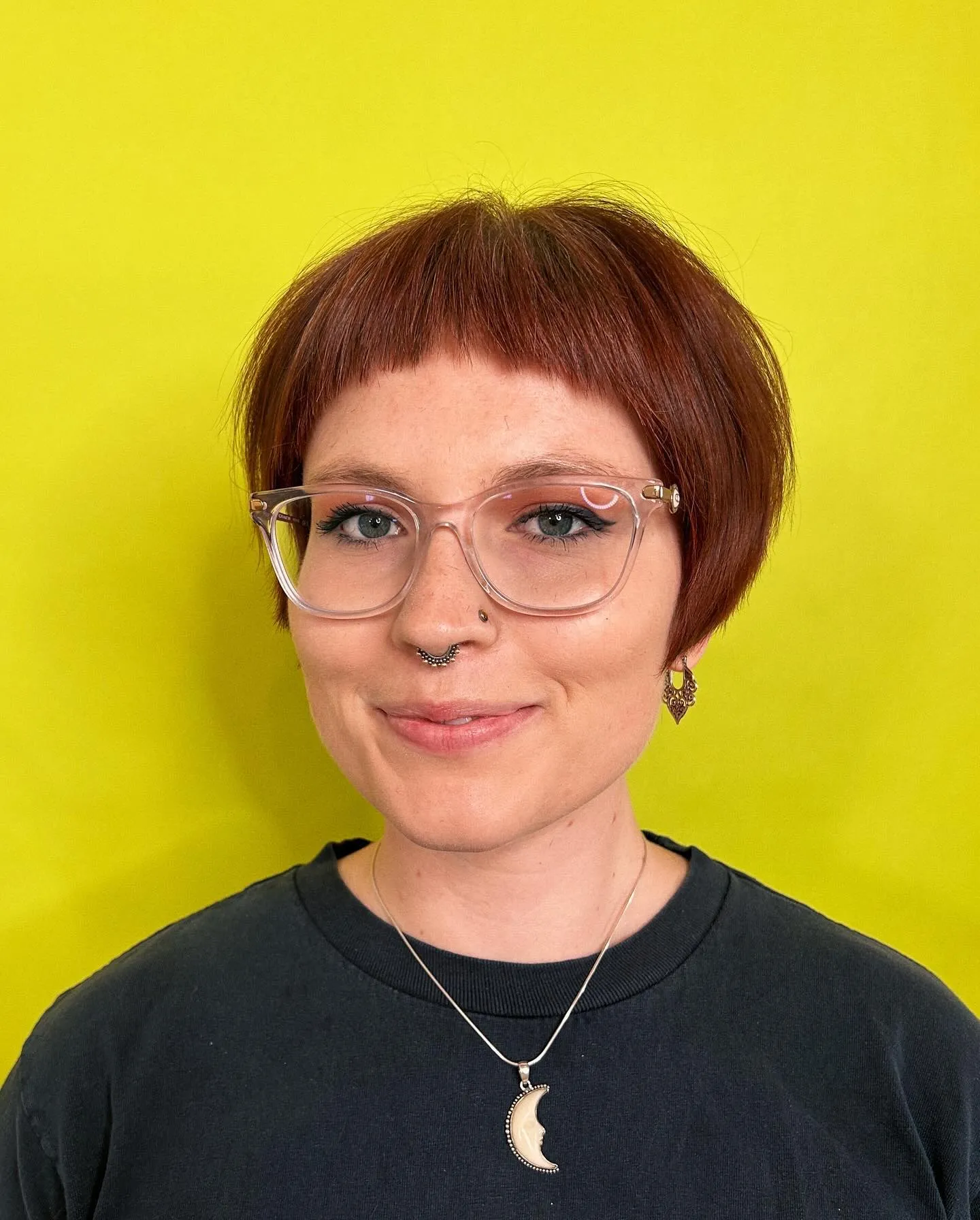 Rounded copper micro bob with short straight bangs and tucked sides