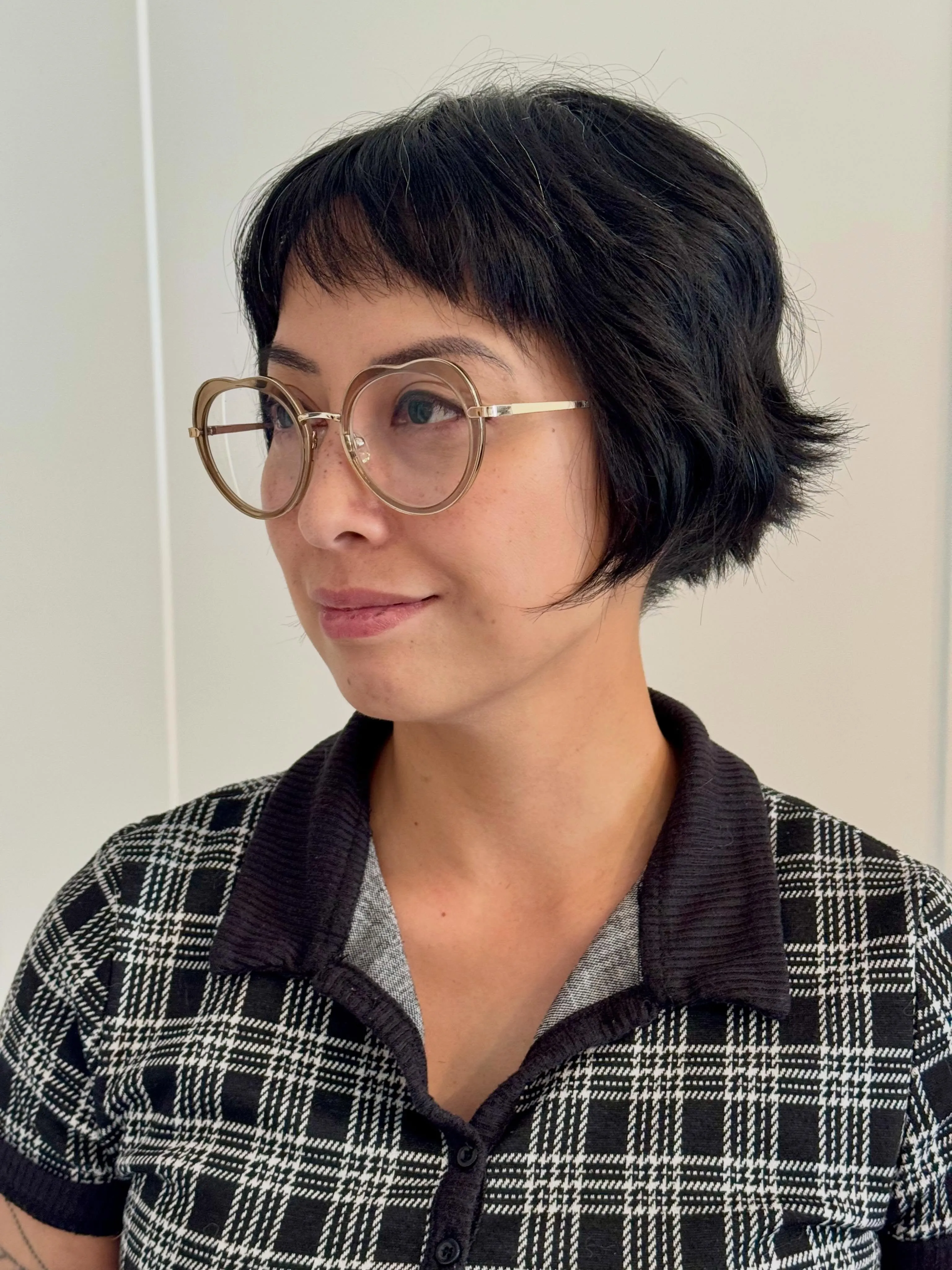 Dark textured micro bob with baby bangs and softly flipped ends