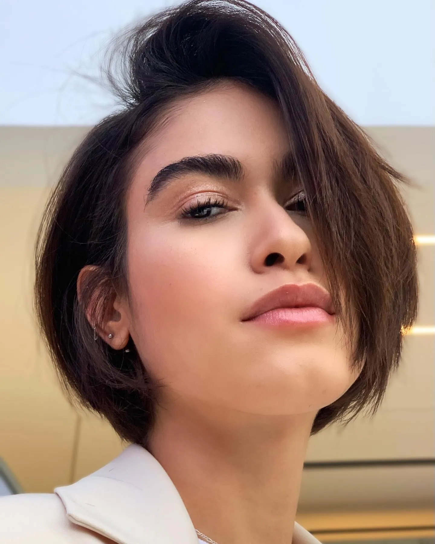 Sleek dark micro bob with a deep side sweep and tucked side