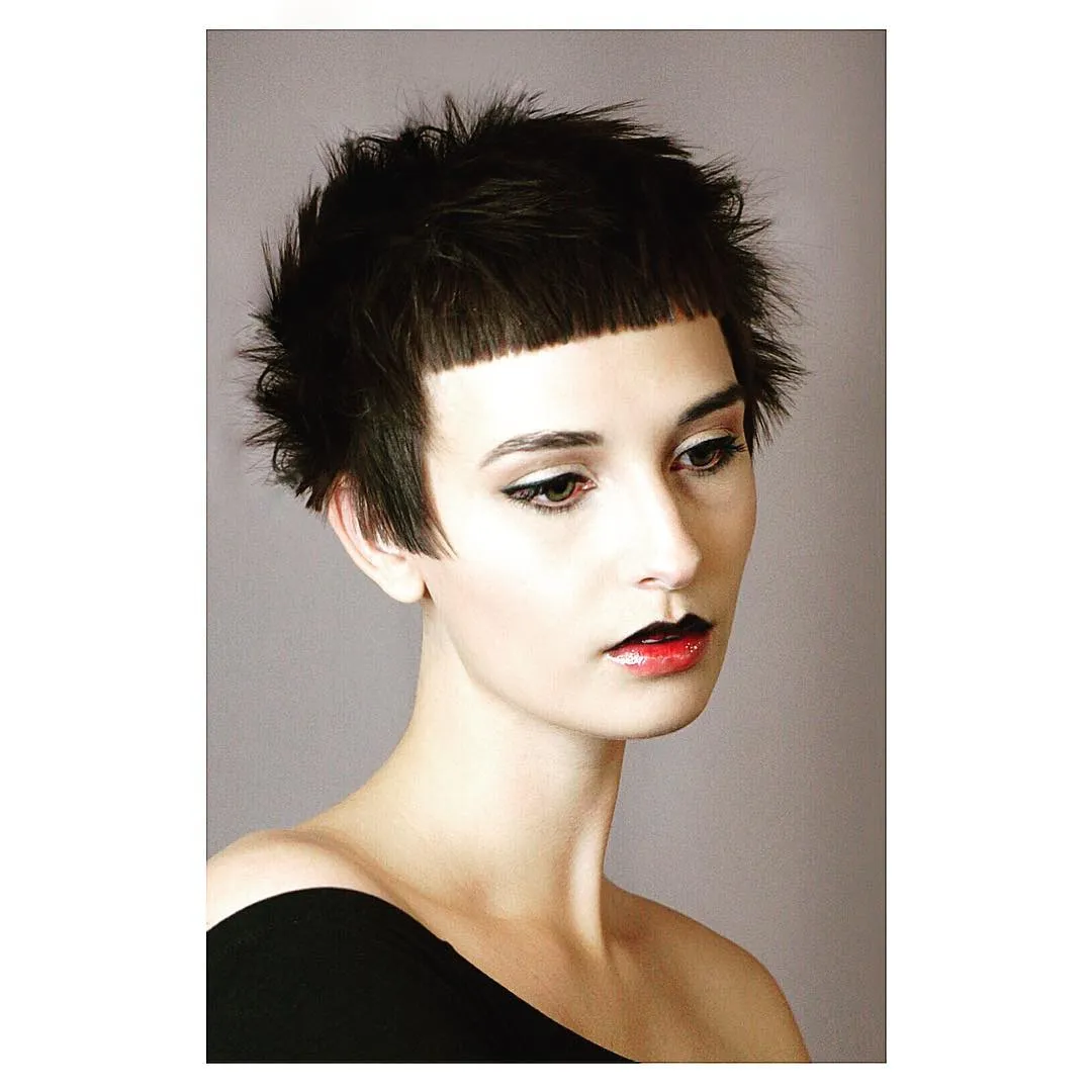 Very short dark micro bob with blunt baby bangs and spiky texture