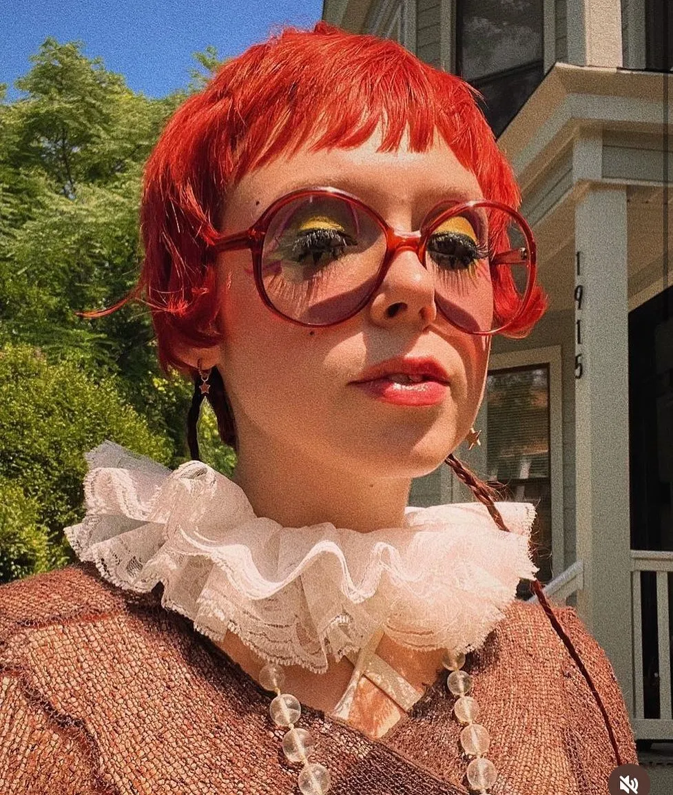 Bright red micro bob with choppy baby bangs and flipped side pieces