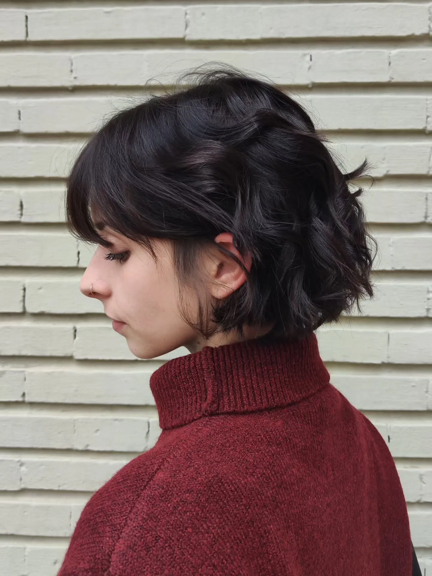 Short dark bob with tousled waves and face-framing pieces
