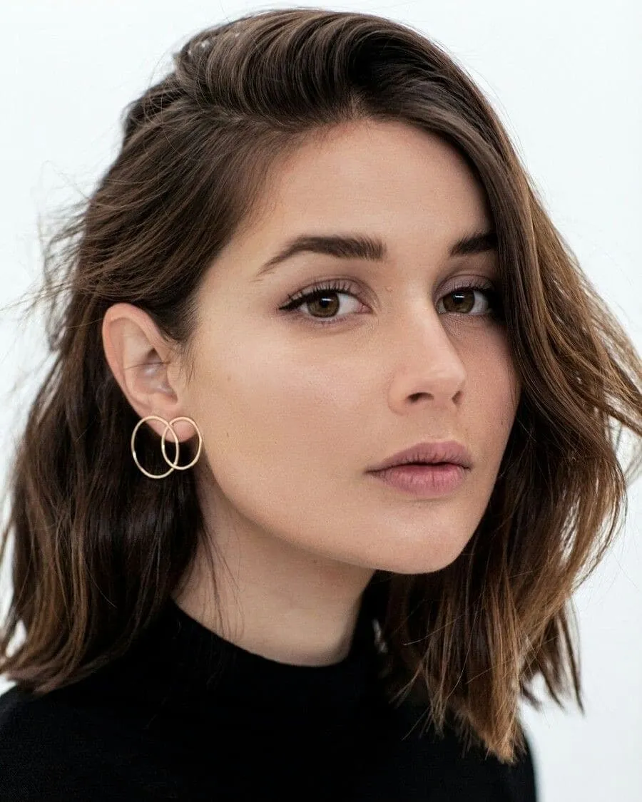 Wavy brunette bob with a deep side part