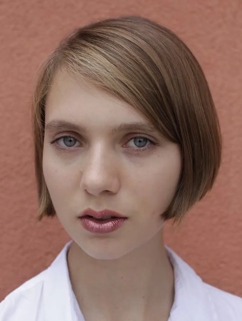 Sleek side-parted mini bob tucked behind the ear