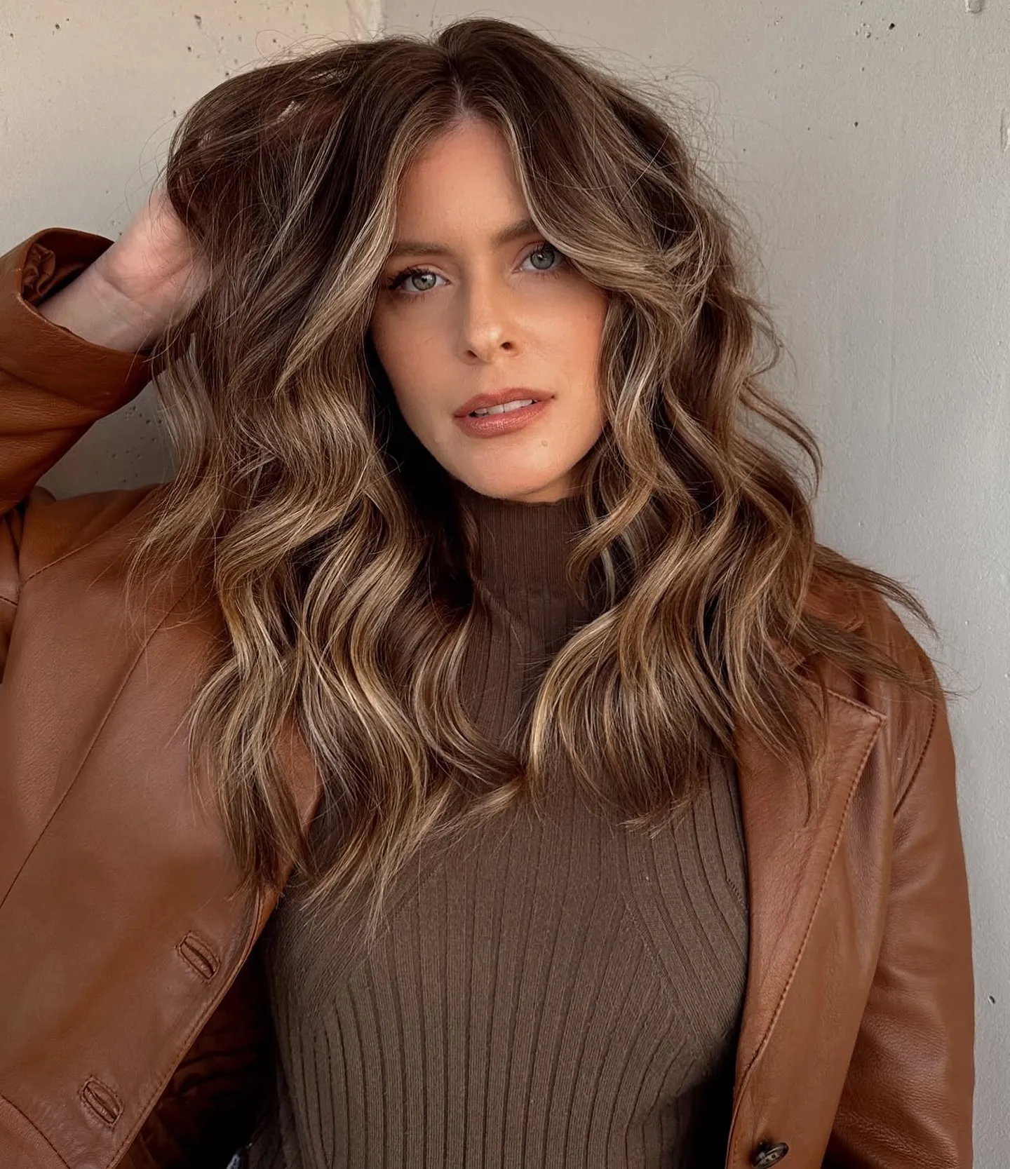 Long brunette waves with soft blonde face-framing highlights