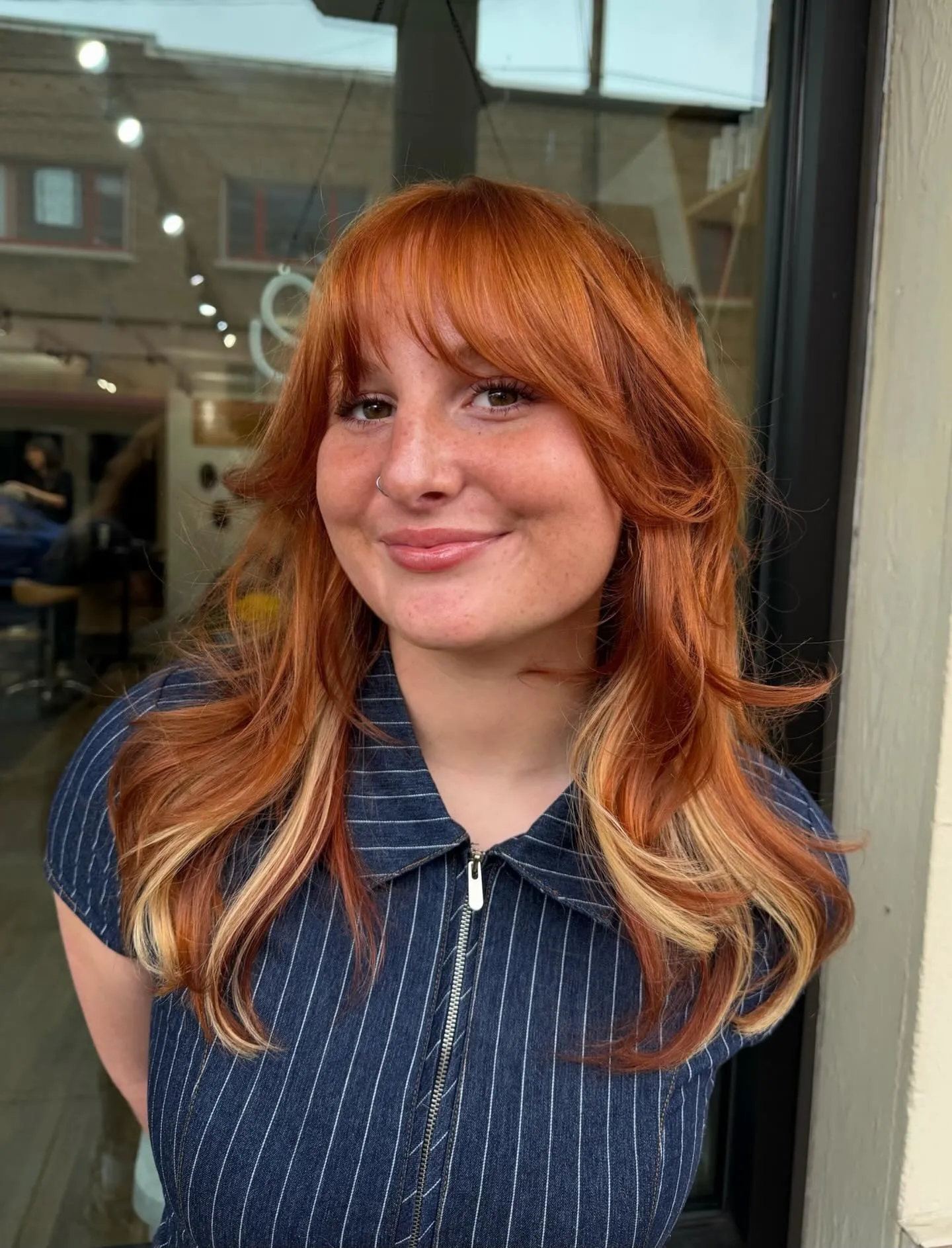 Shoulder-length copper layers with full fringe and pale face-framing pieces