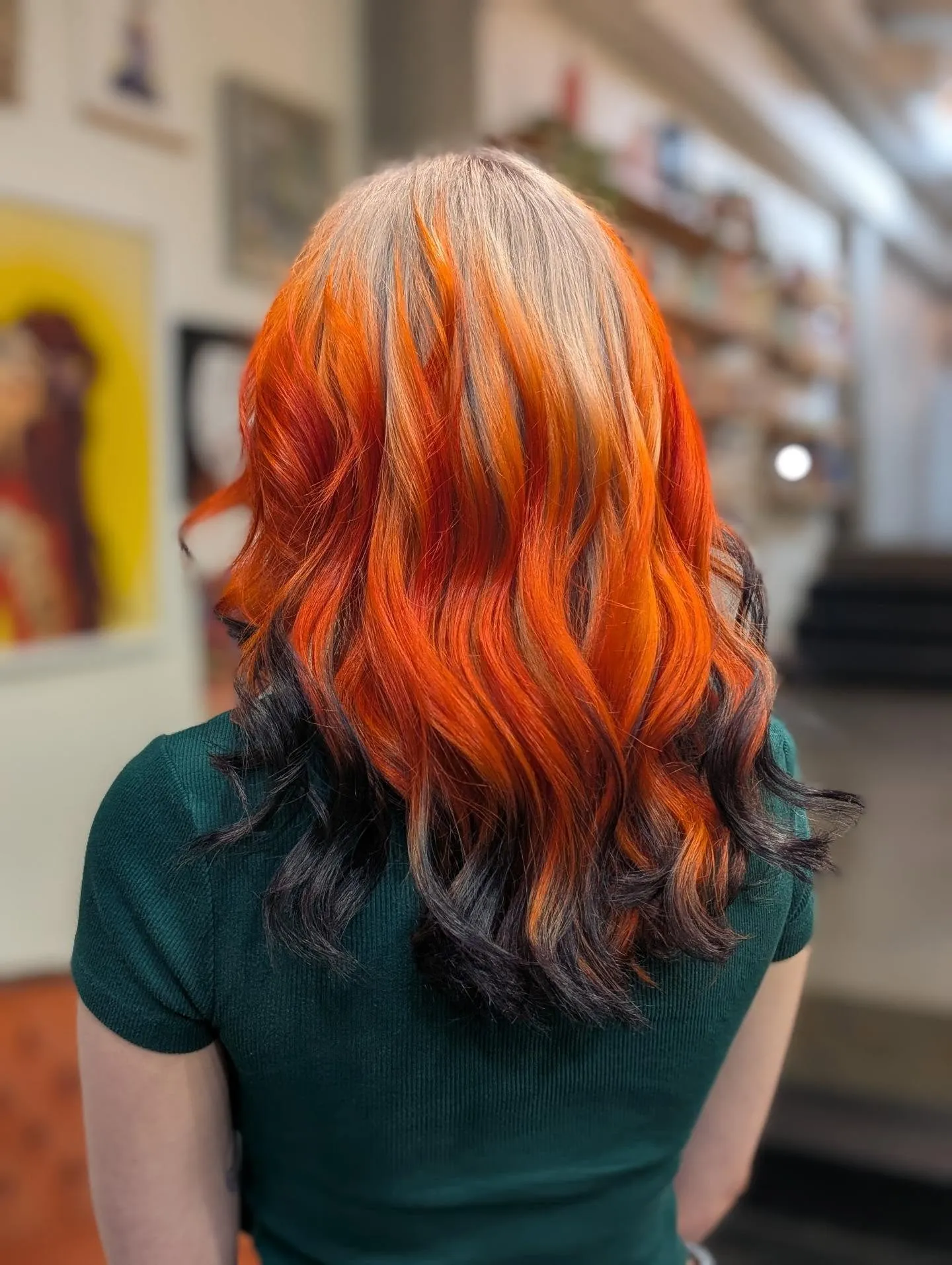 Back view of wavy hair with vivid orange panels over dark ends