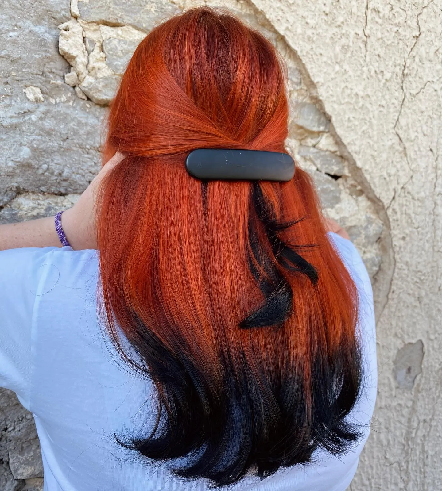 Long half-up red hair fading into black ends