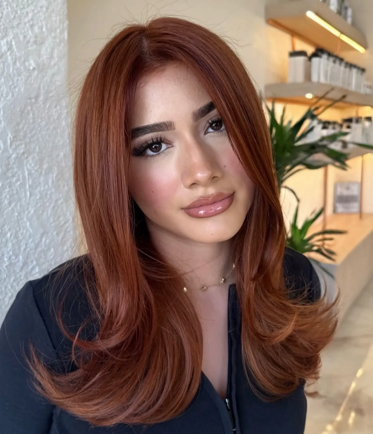 Long sleek copper layers with center part and curved face-framing ends
