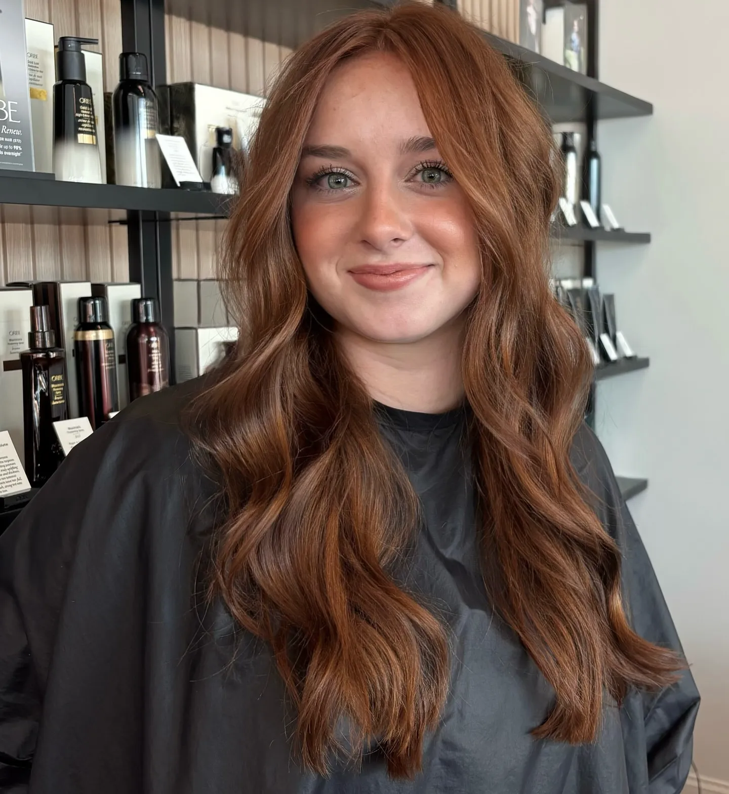 Long auburn hair with center part and soft loose waves