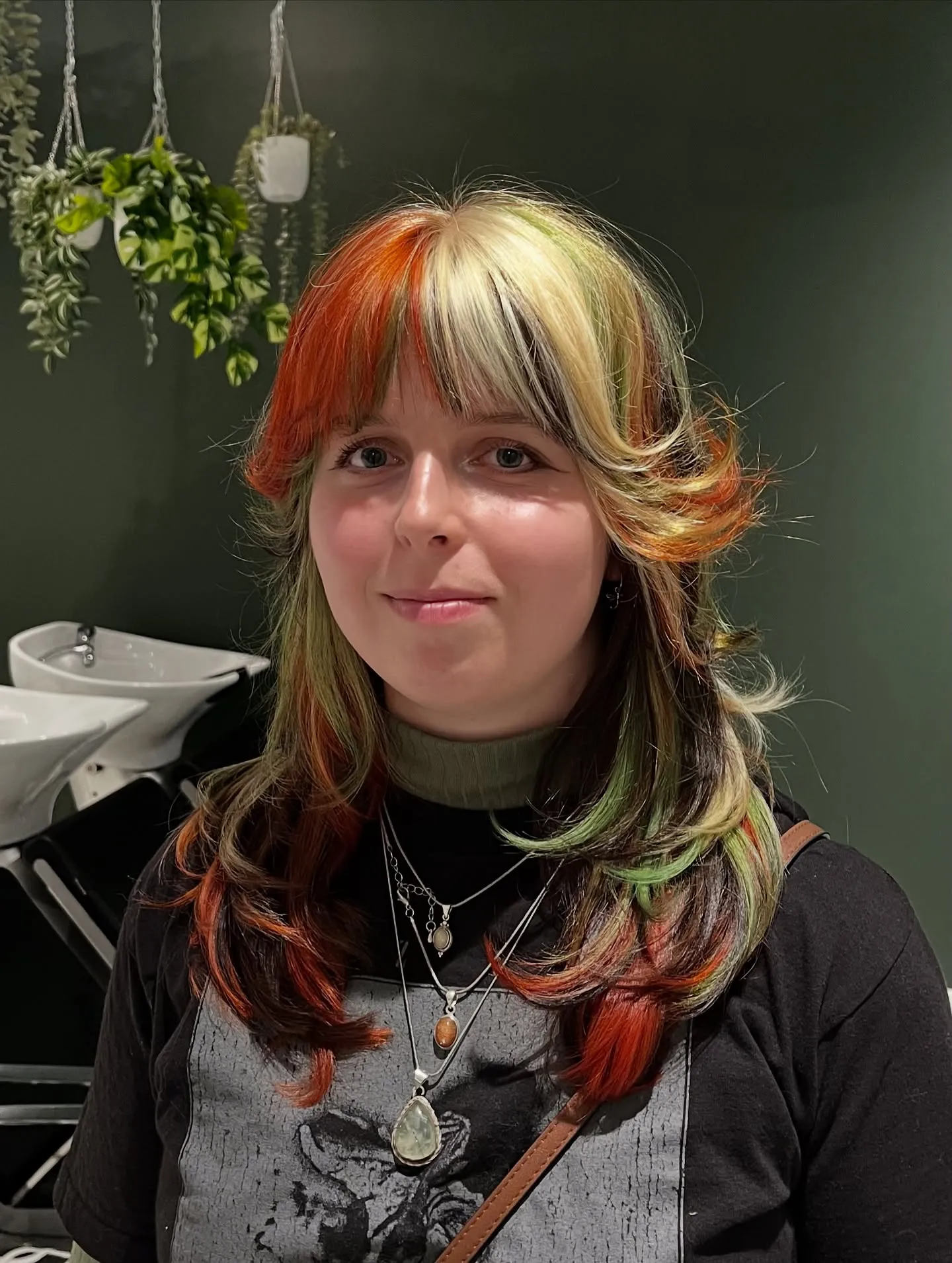 Layered shag with bangs and red, green and pale blonde streaks