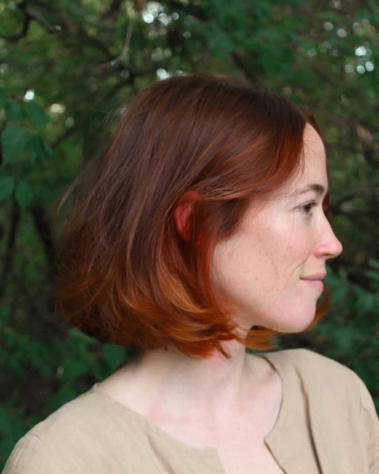 Short side-parted copper bob with softly curved ends