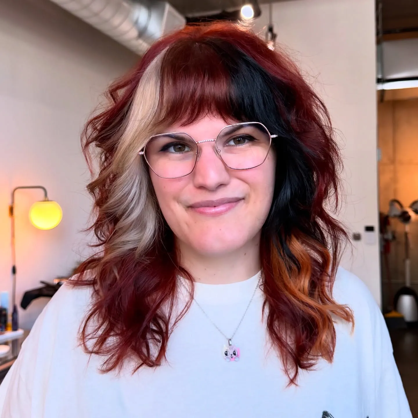 Wavy shoulder-length shag with red and black split colour and bangs