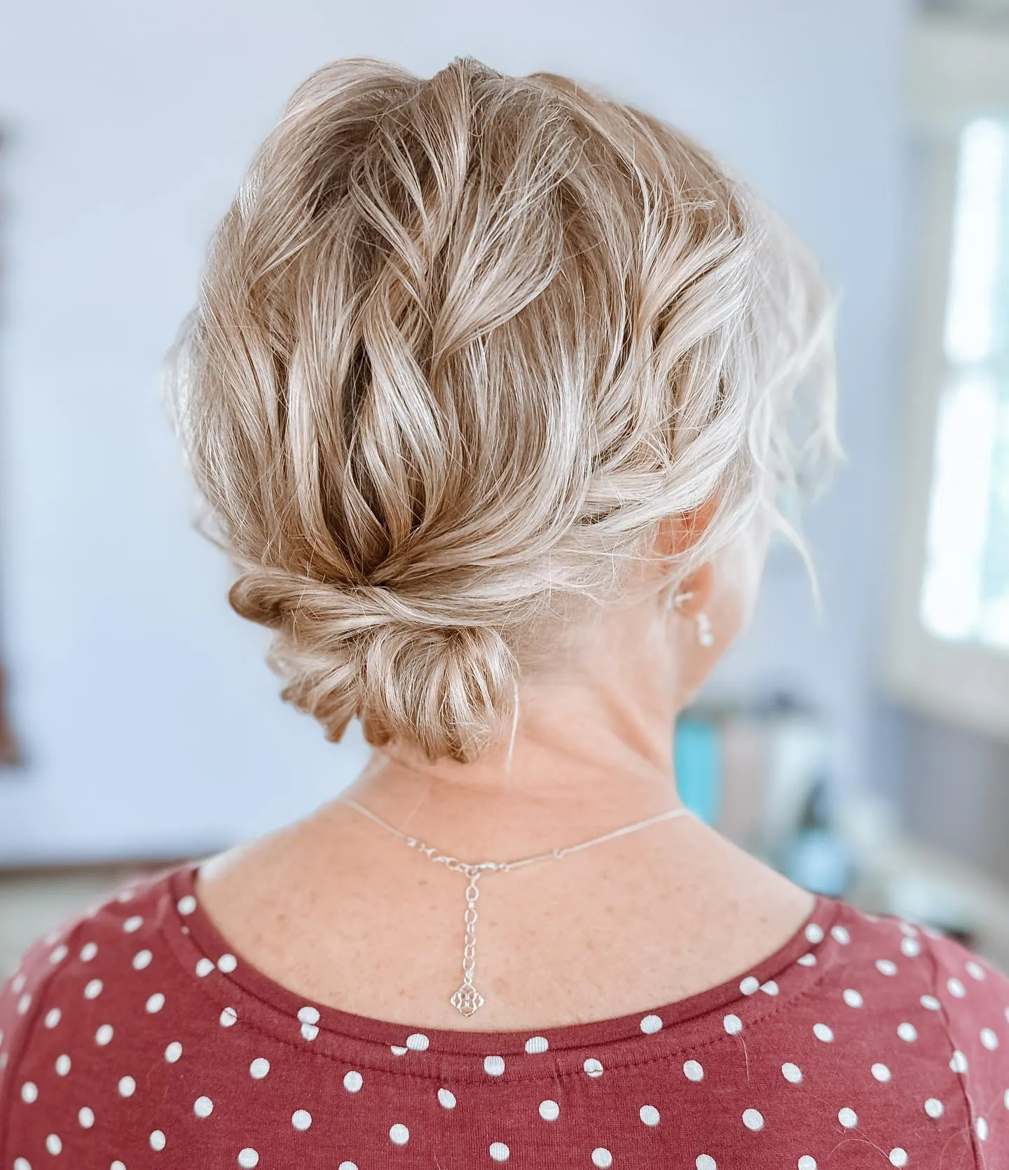 Soft knotted low bun on blonde hair