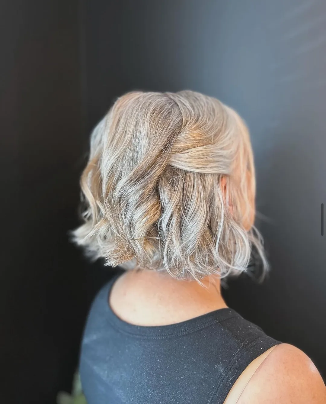 Short silver blonde wavy bob pinned half up