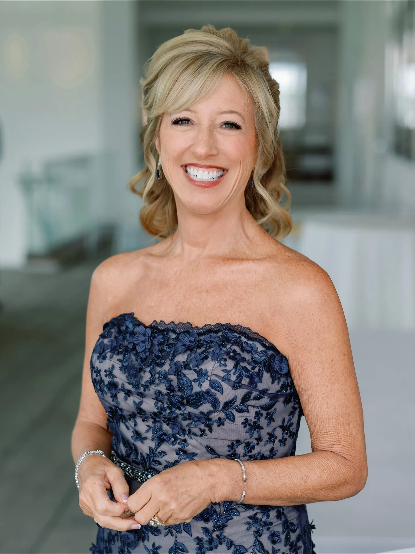 Blonde side-swept formal curls with a lifted crown