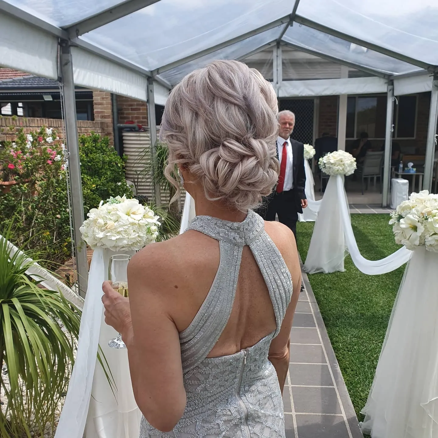 Textured braided low updo on silver blonde hair