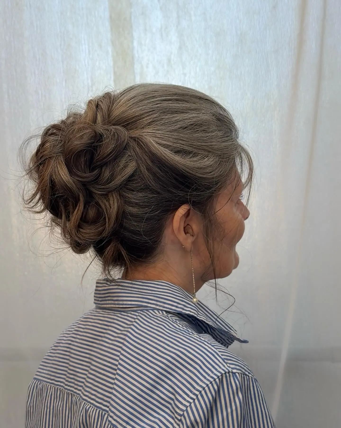 Curly high updo on medium brown hair